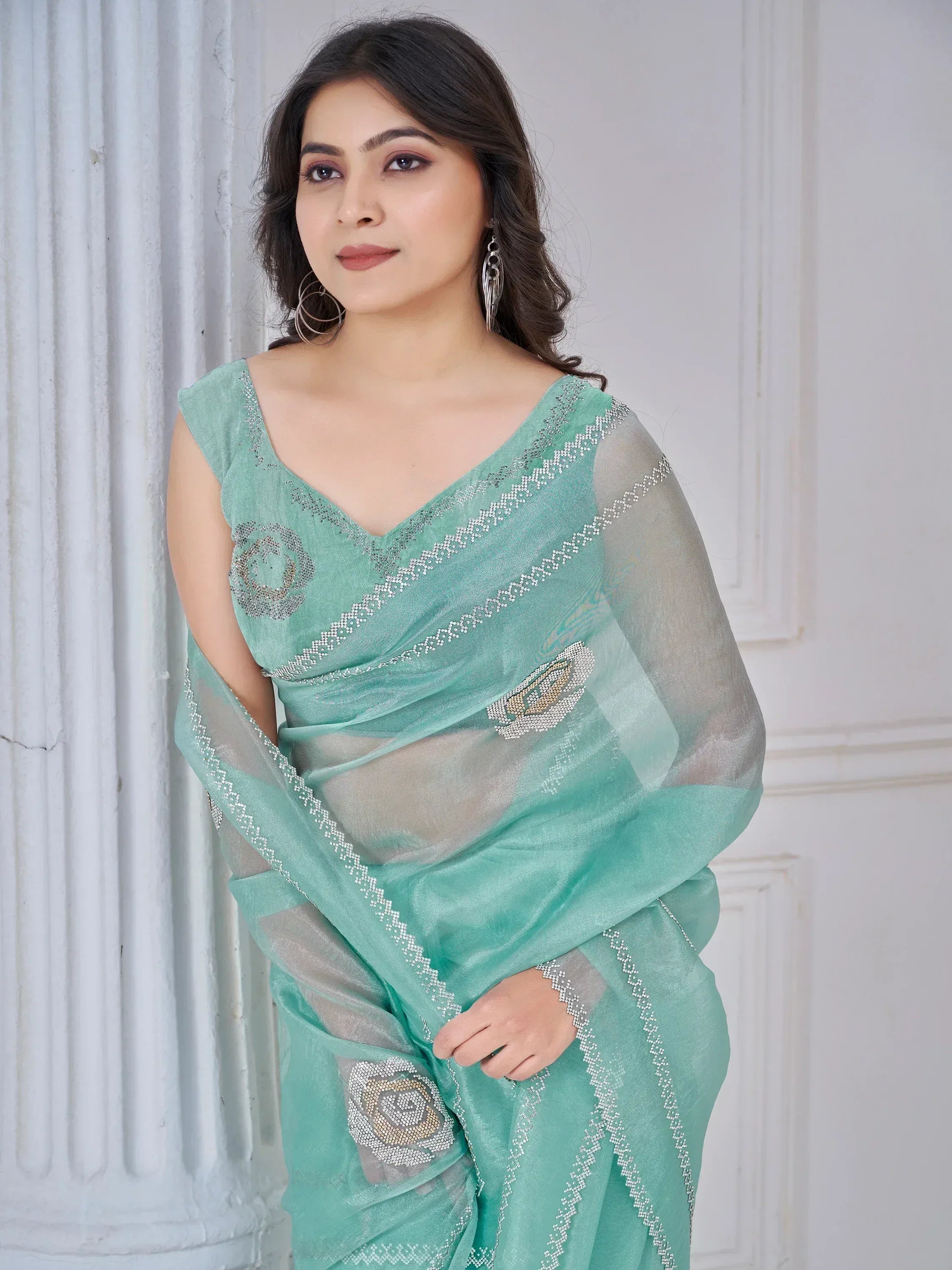 Mint green designer saree with floral beadwork and sheer blouse, perfect for ethnic occasions