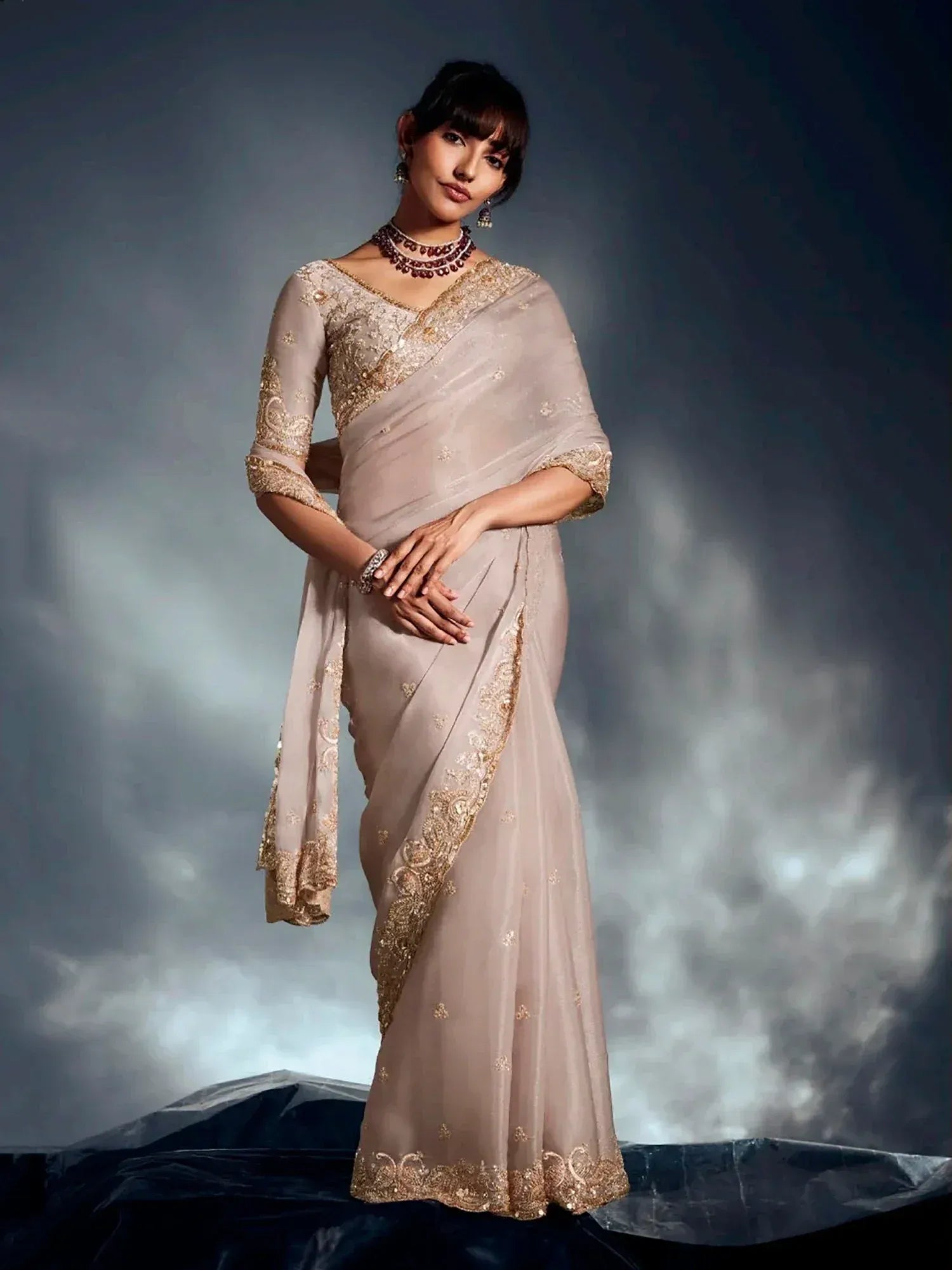 Elegant beige saree with gold embroidery, perfect for Indian ethnic wear and festive occasions.