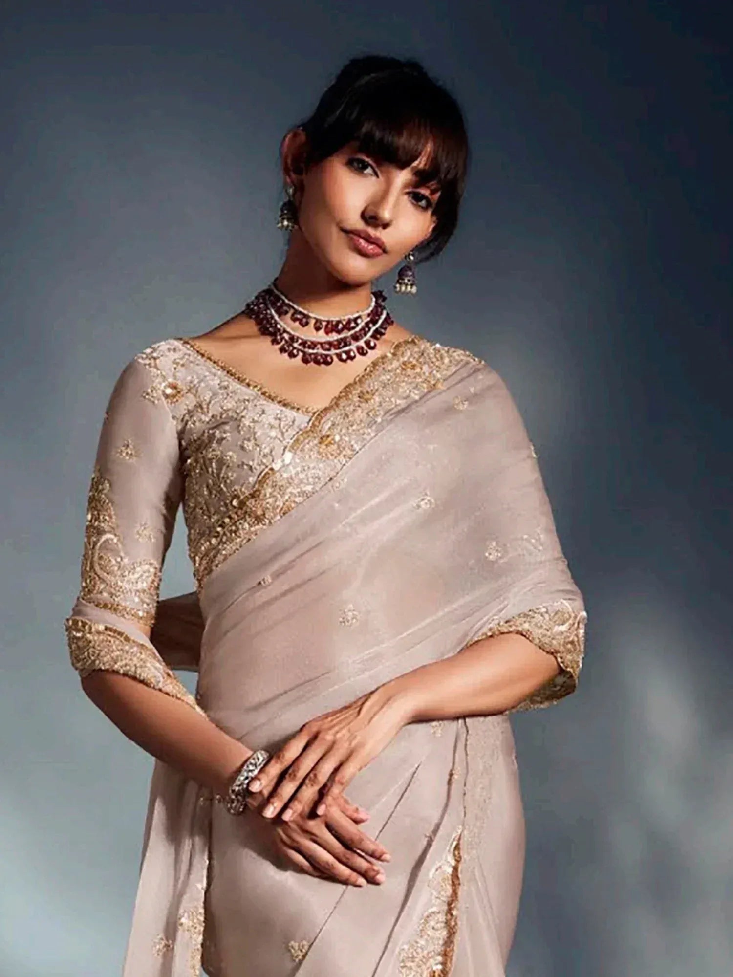 Elegant beige saree with gold embroidery, perfect for Indian ethnic wear occasions