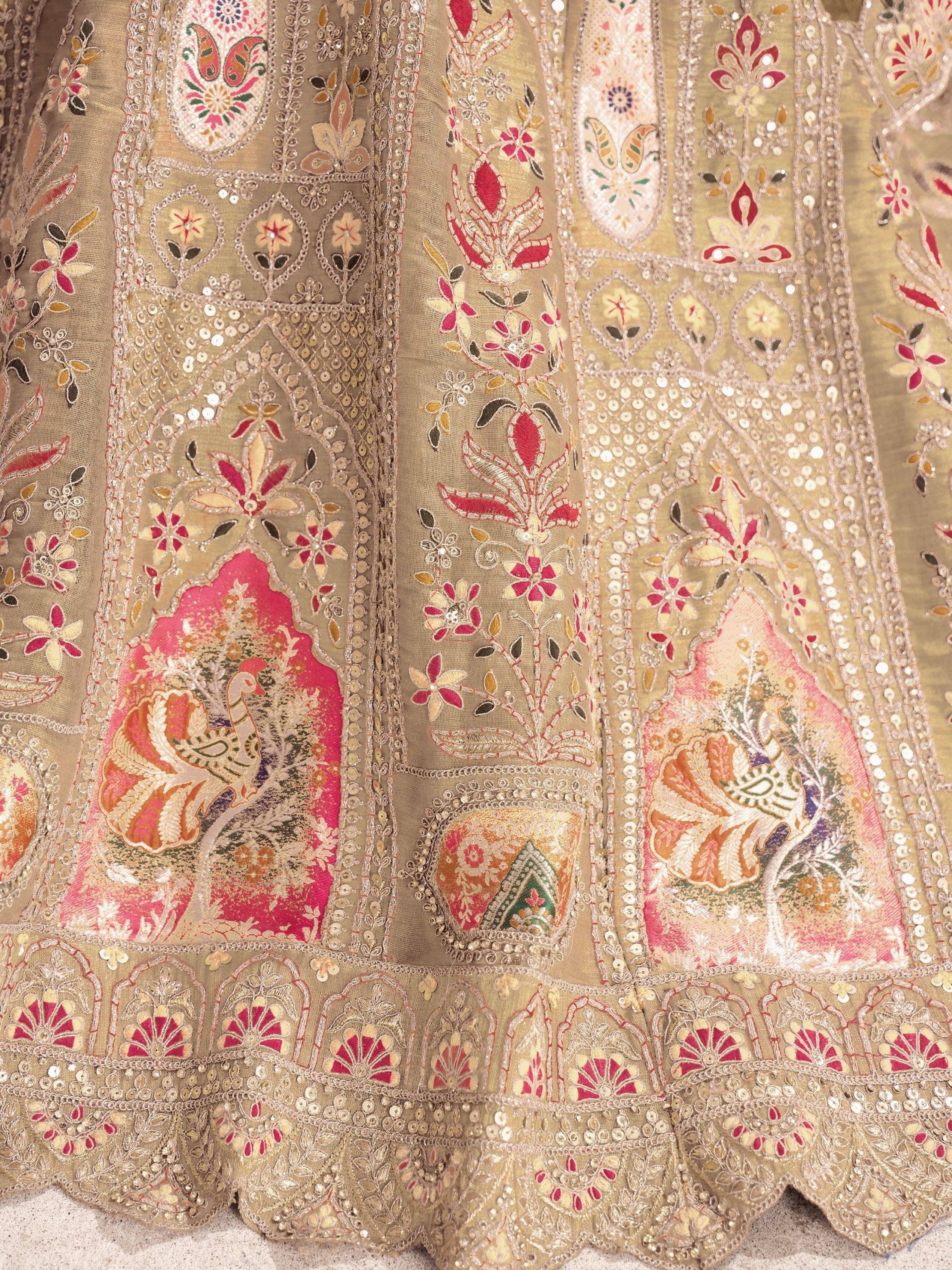 Beige lehenga with pink peacock embroidery, floral motifs, and sequin detailing for Indian ethnic wear