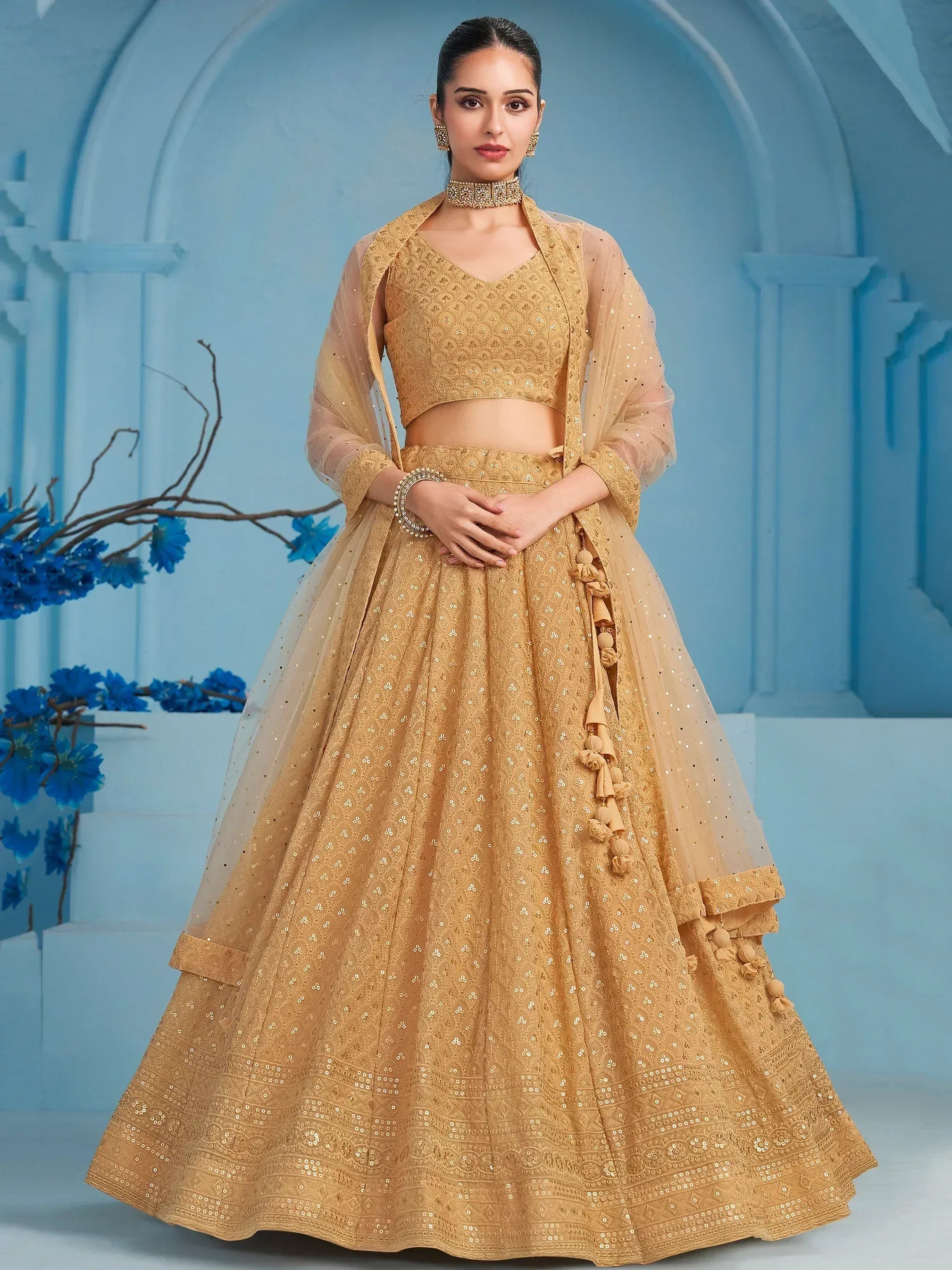 Golden designer lehenga choli with sequin work, sheer dupatta, and tassels for Indian ethnic wear