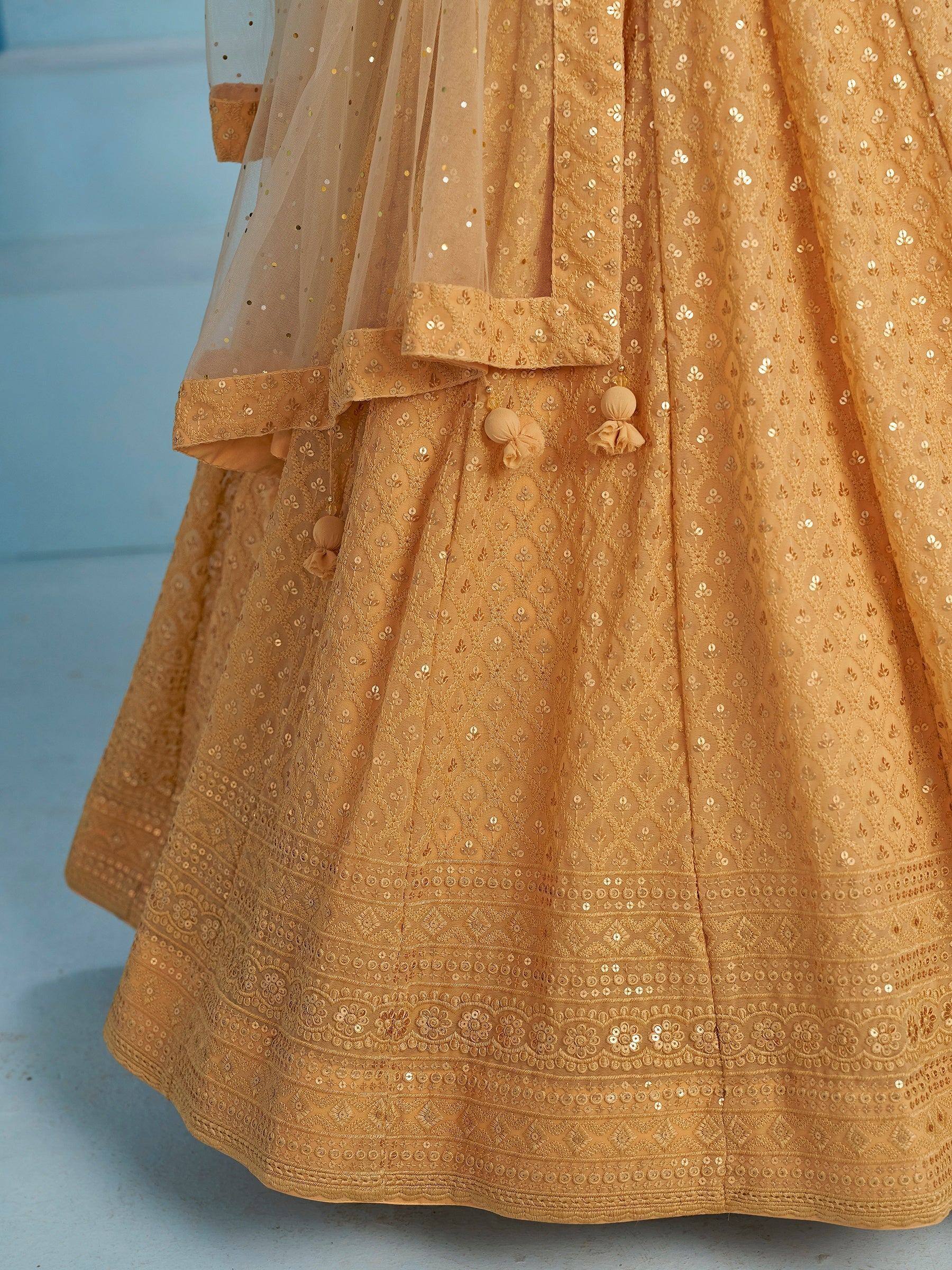 Golden sequin-embroidered lehenga with tassel details and sheer dupatta, ideal for Indian ethnic wear occasions.