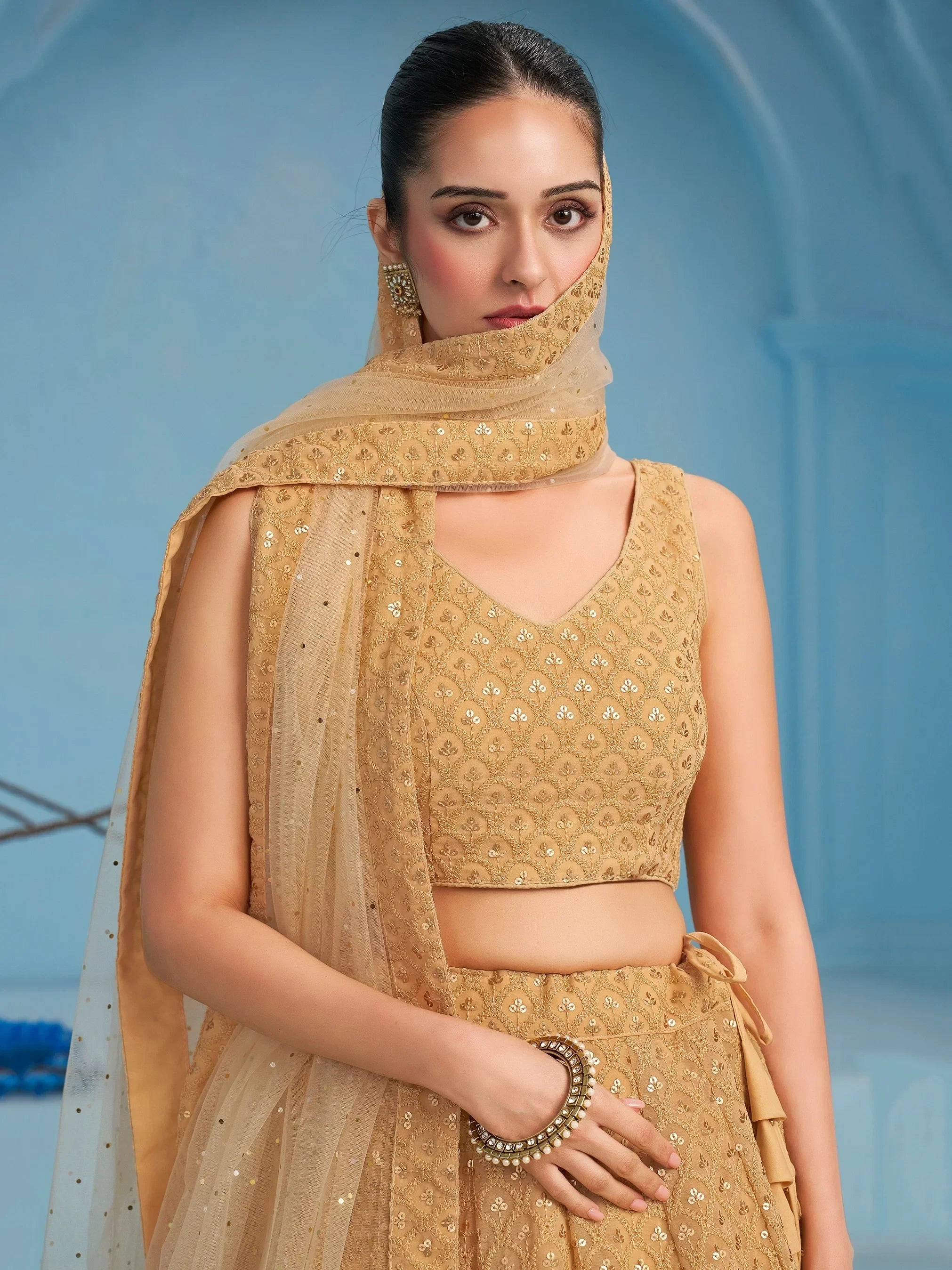 Golden embroidered lehenga choli with matching dupatta, perfect for Indian ethnic wear occasions