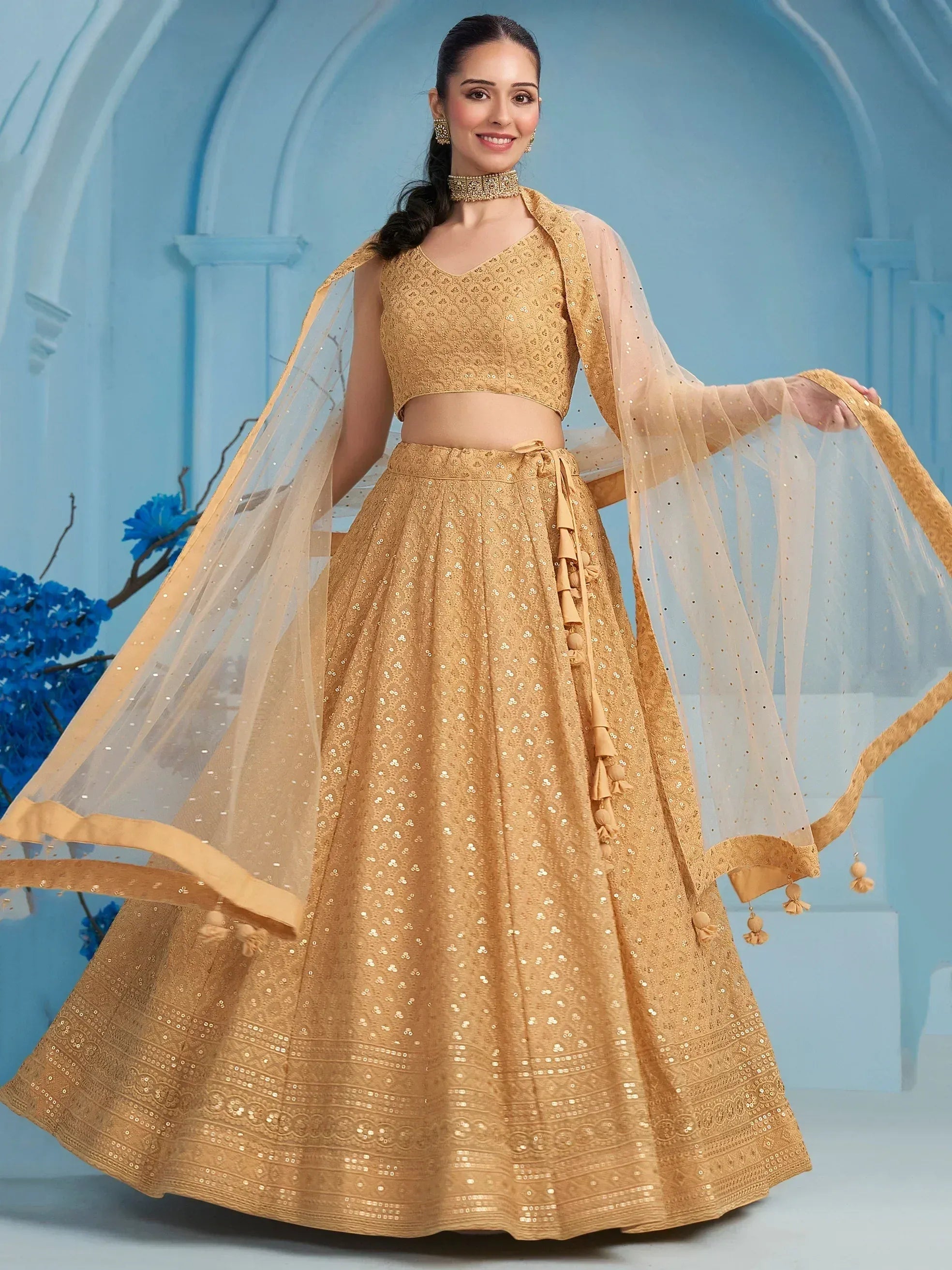 Golden sequined lehenga choli with sheer dupatta, perfect for Indian ethnic occasions and weddings