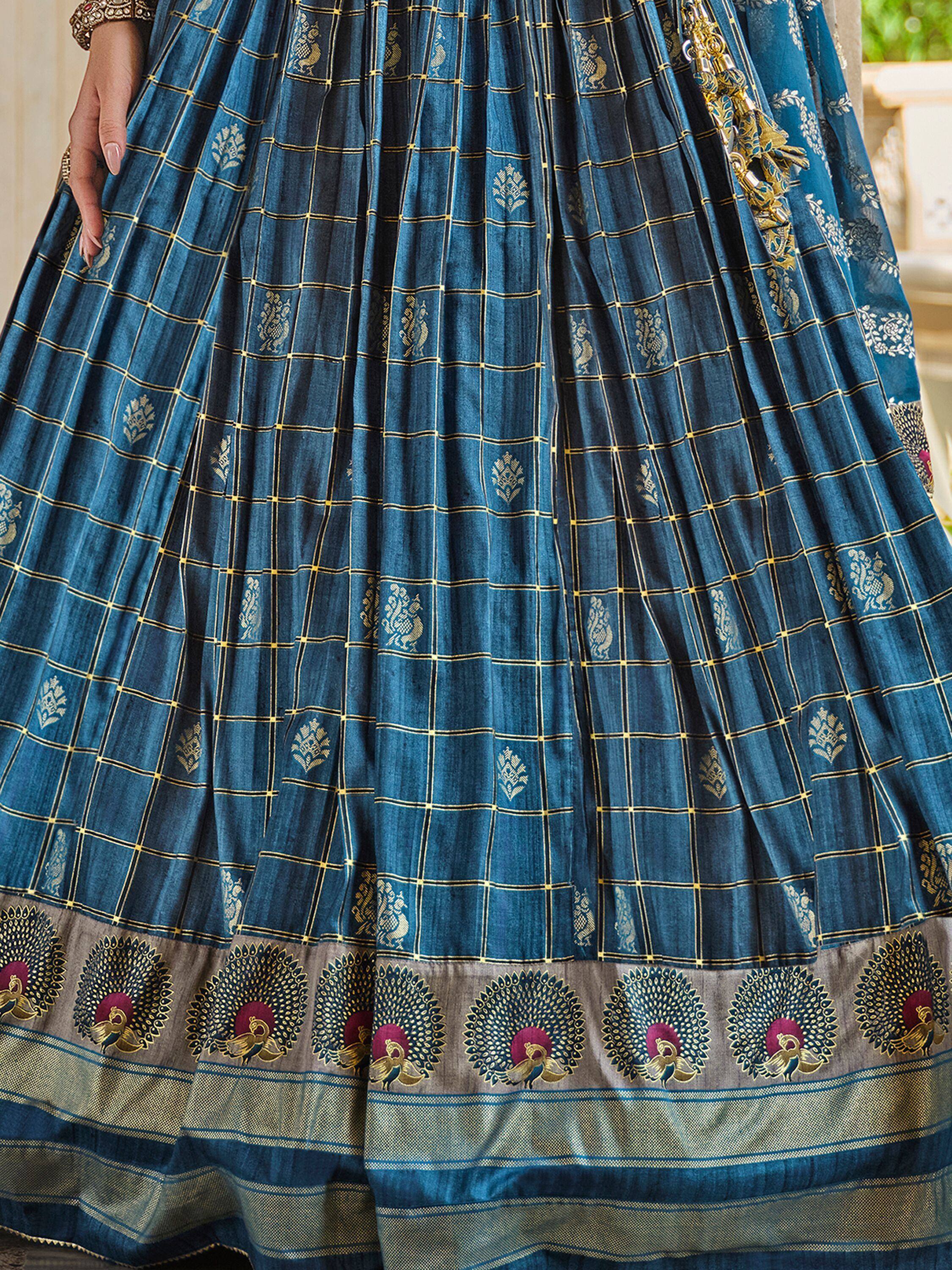 Blue ethnic lehenga with gold checkered print and peacock border, perfect for Indian weddings and festivals.