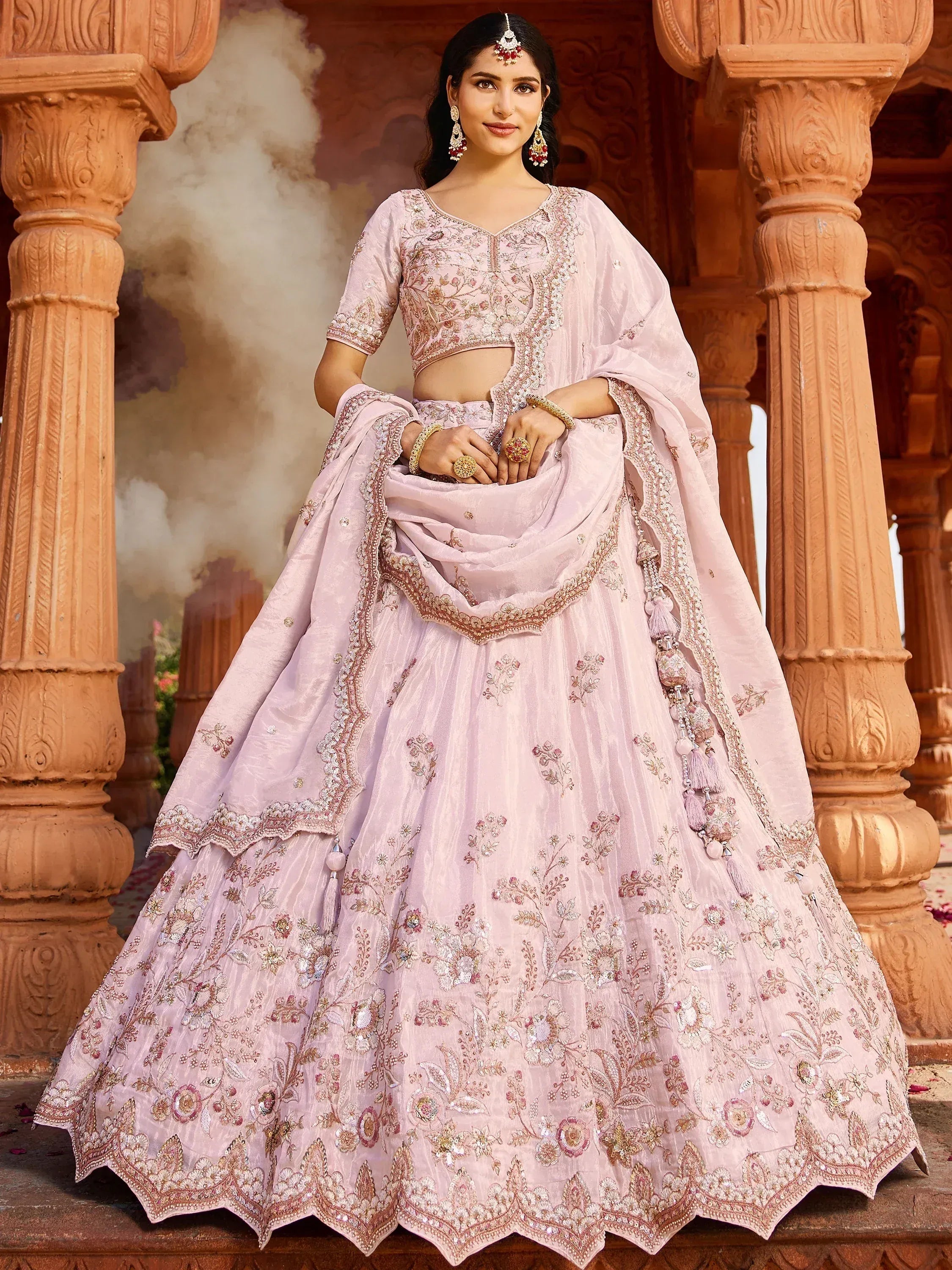 Pink embroidered lehenga choli with floral motifs, perfect for Indian weddings and ethnic events