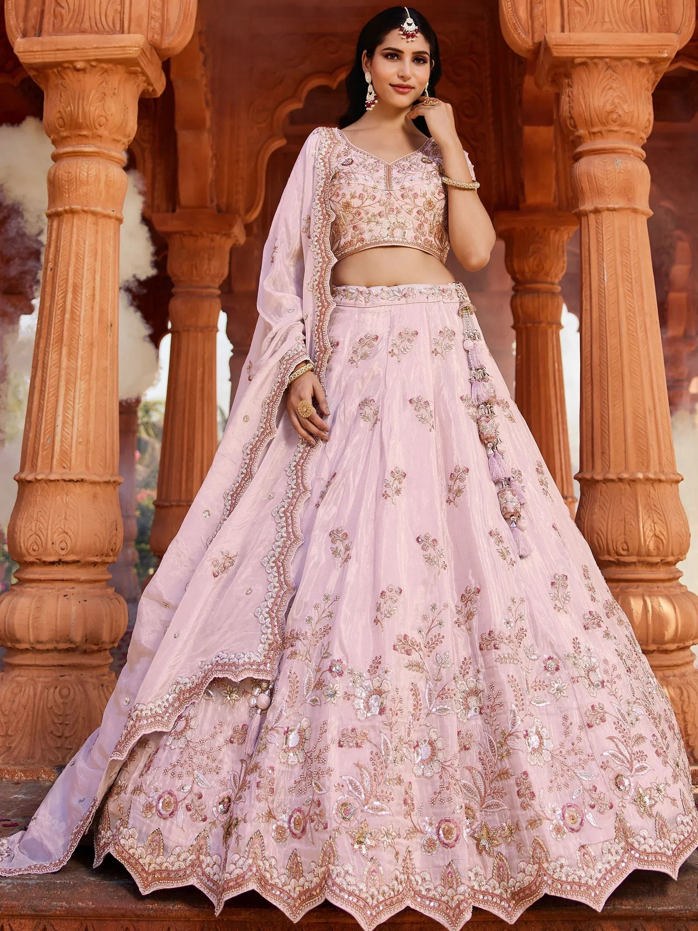 Pink embroidered lehenga choli with floral detailing, perfect for Indian weddings and festive occasions.