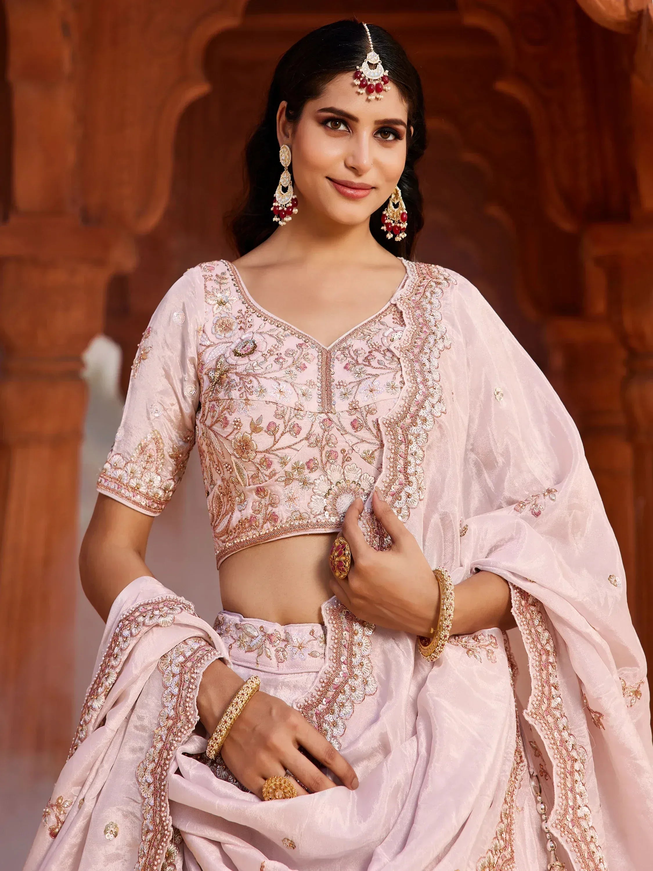 Pink embroidered lehenga choli with floral detailing, perfect for Indian weddings and festive occasions