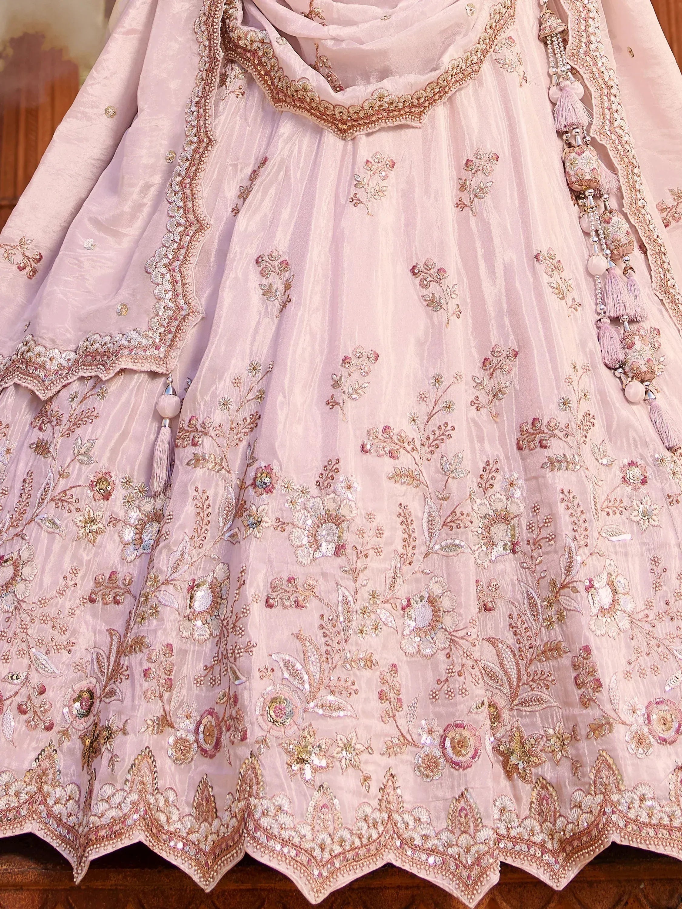 Pink embroidered lehenga choli with floral motifs and tassels, Indian ethnic wear