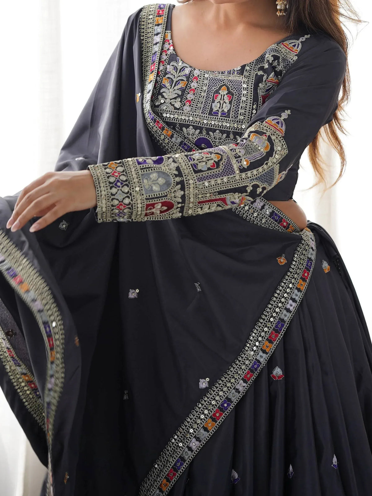 Black embroidered lehenga choli with colorful floral mirror work, perfect for Indian ethnic wear