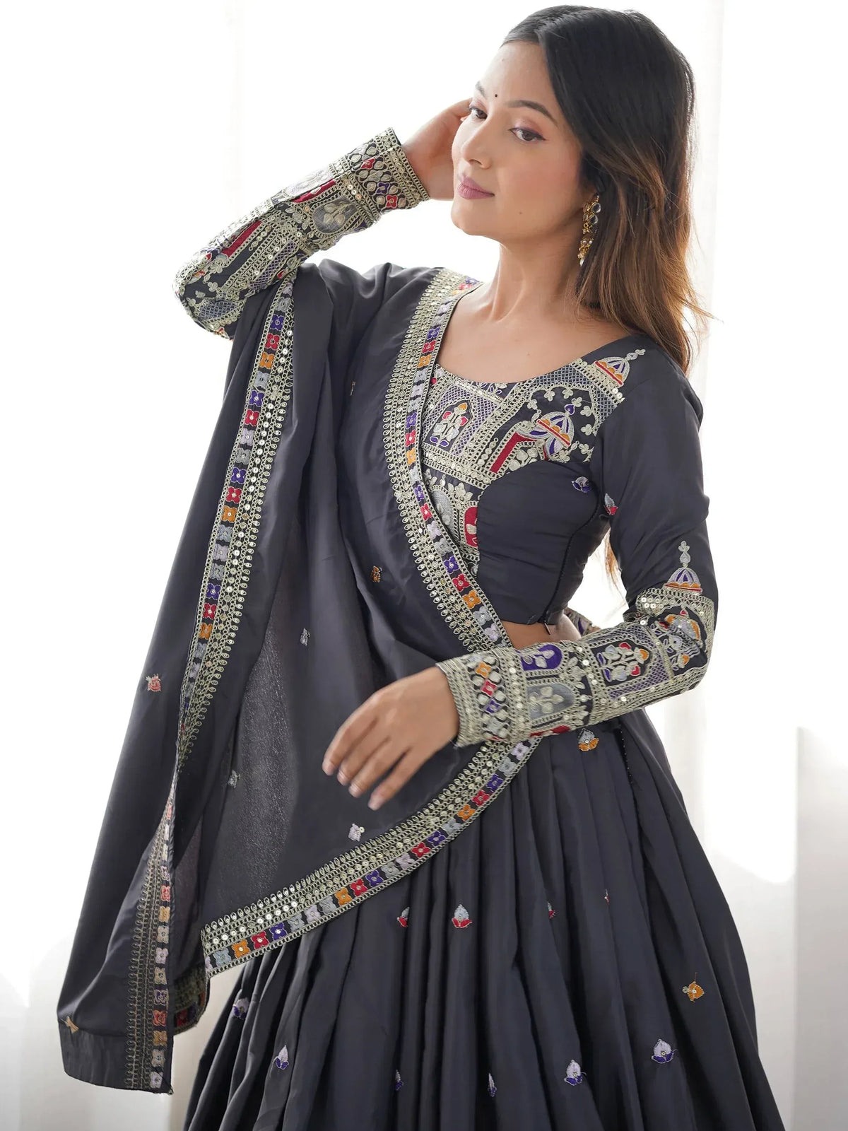 Grey embroidered lehenga choli with colorful floral motifs and mirror work, perfect for Indian ethnic wear.