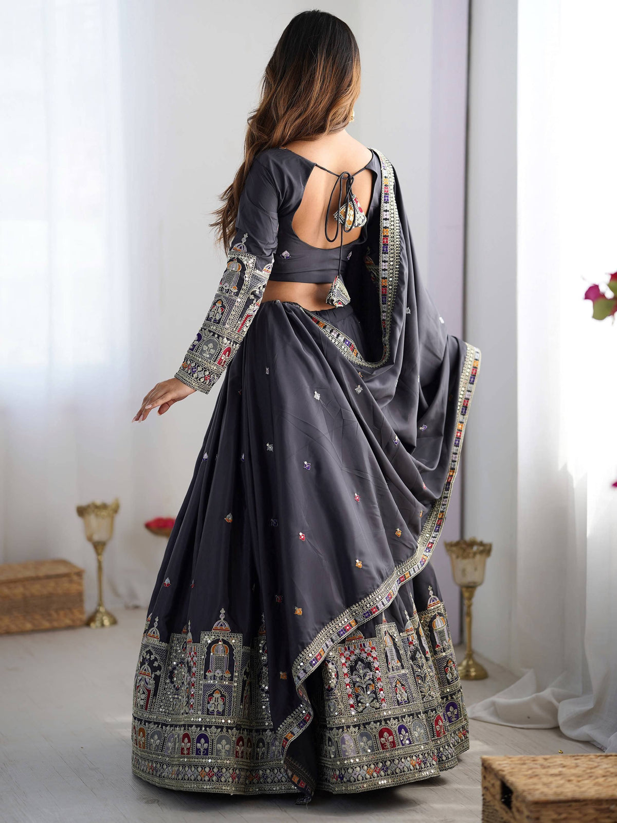 Grey designer lehenga choli with intricate embroidery and mirror work, perfect for Indian ethnic occasions.