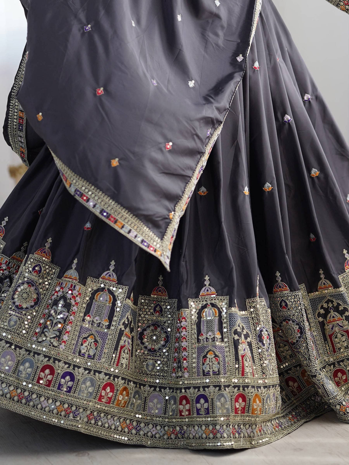 Grey designer lehenga choli with intricate temple embroidery and mirror work, perfect for Indian ethnic wear.