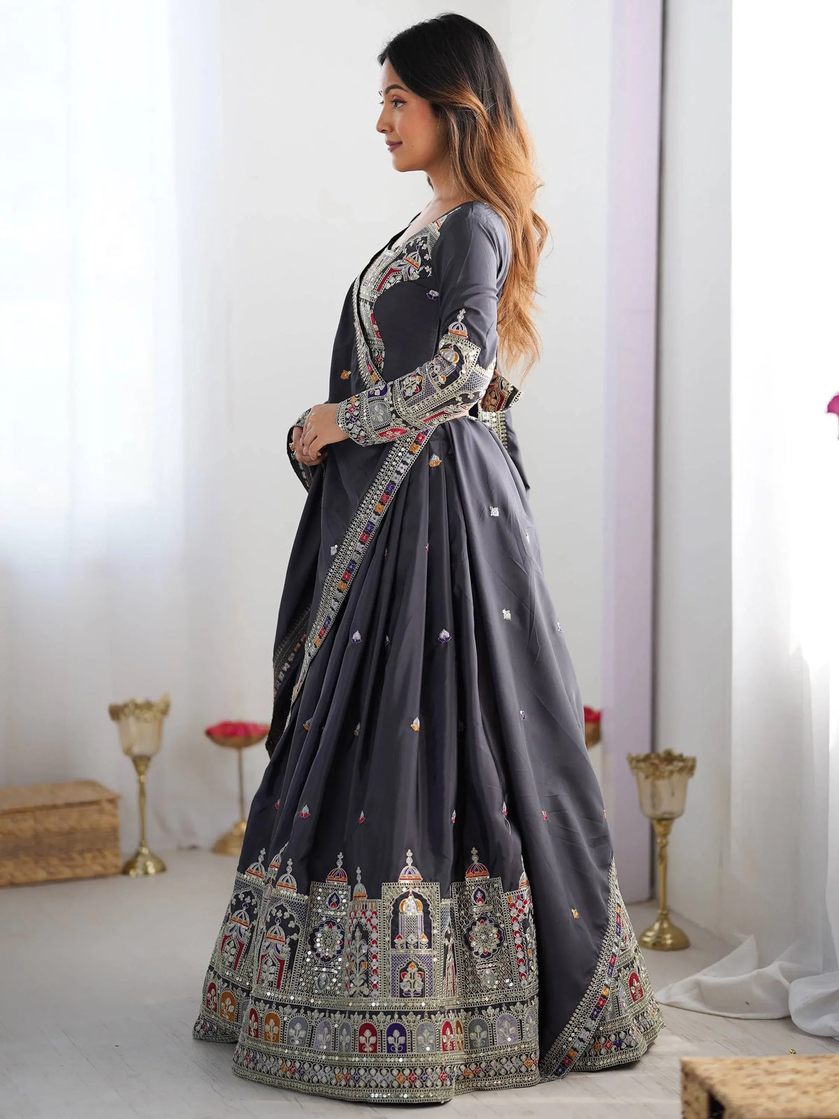 Grey embroidered lehenga choli with intricate temple motifs and mirror work, perfect for Indian ethnic occasions.