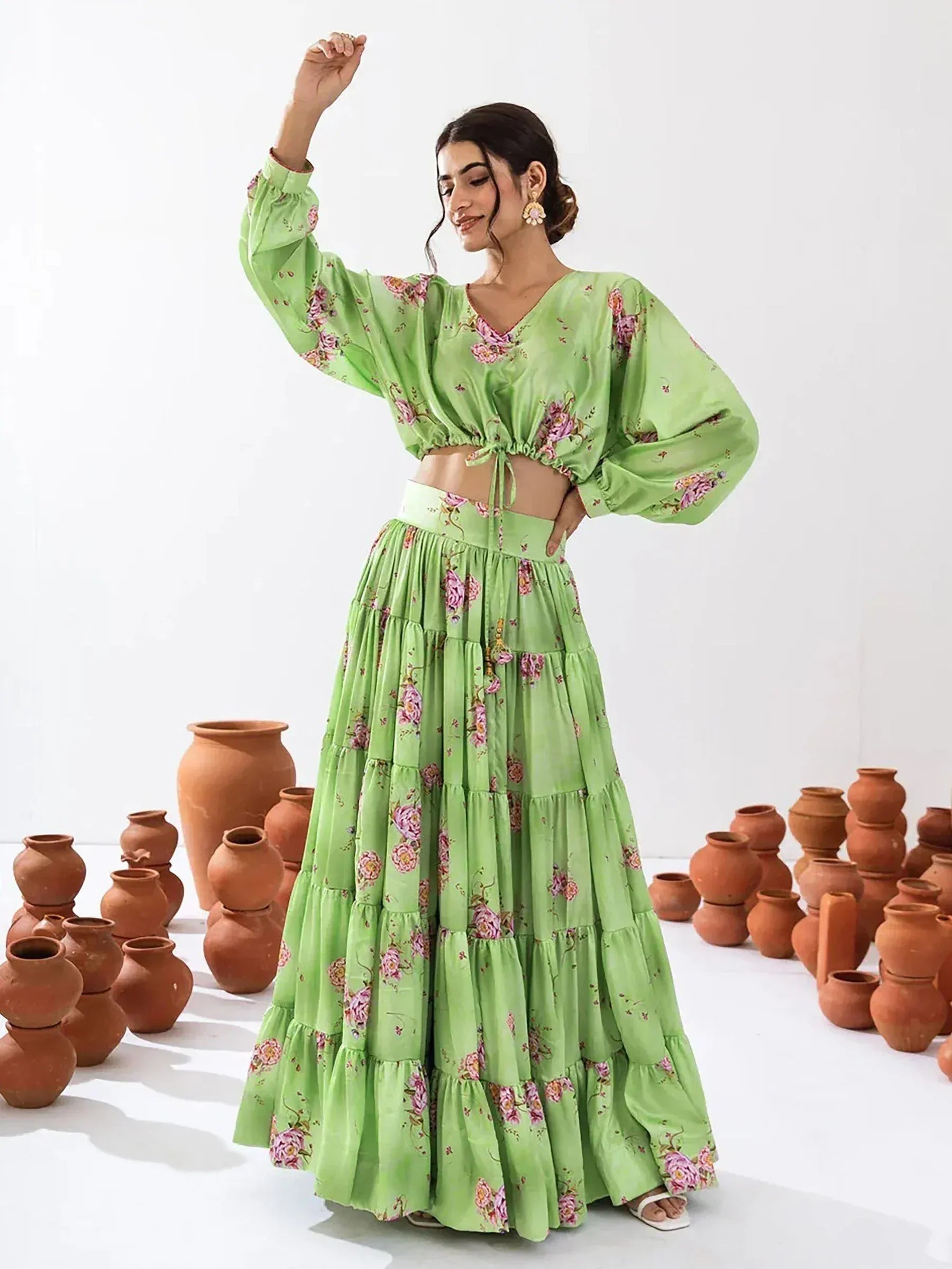 Green floral printed ethnic crop top and tiered skirt set with clay pots background