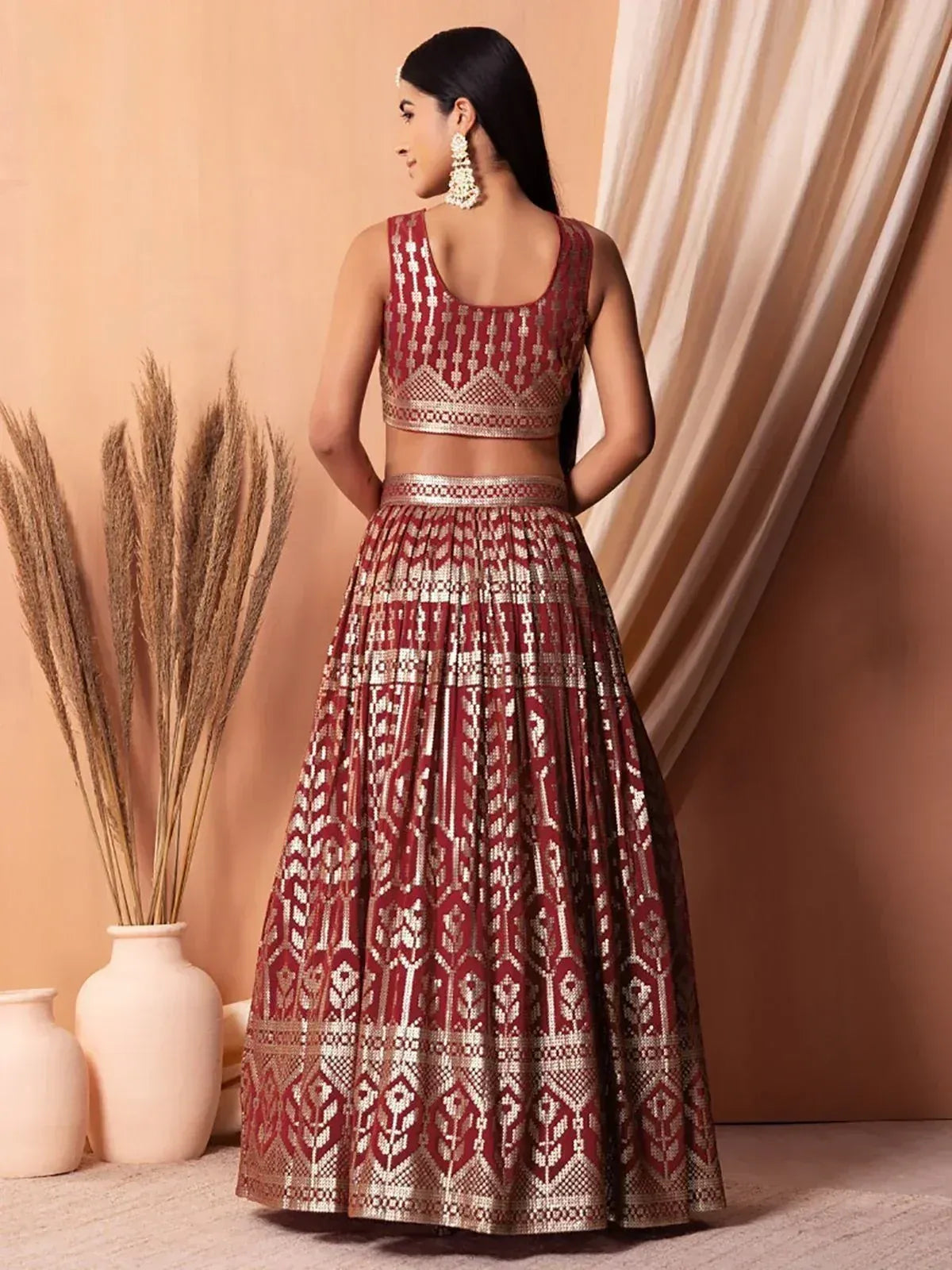 Maroon and gold embroidered lehenga choli with geometric patterns, perfect for Indian ethnic wear occasions