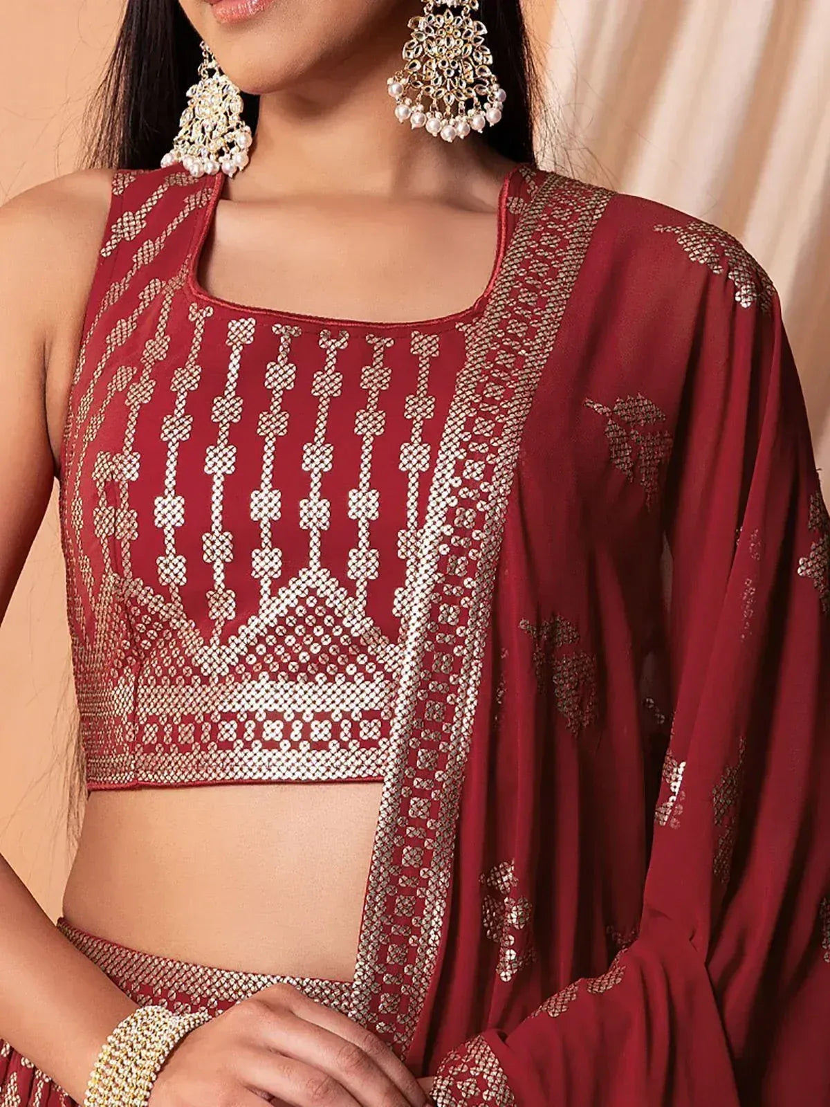 Maroon ethnic crop top with gold embroidery, paired with matching dupatta and jhumka earrings