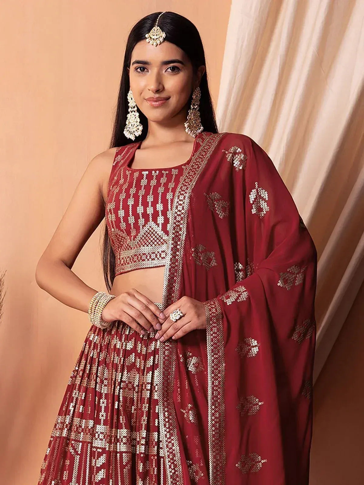 Red embroidered lehenga choli with gold detailing, perfect for Indian ethnic wear and festive occasions.