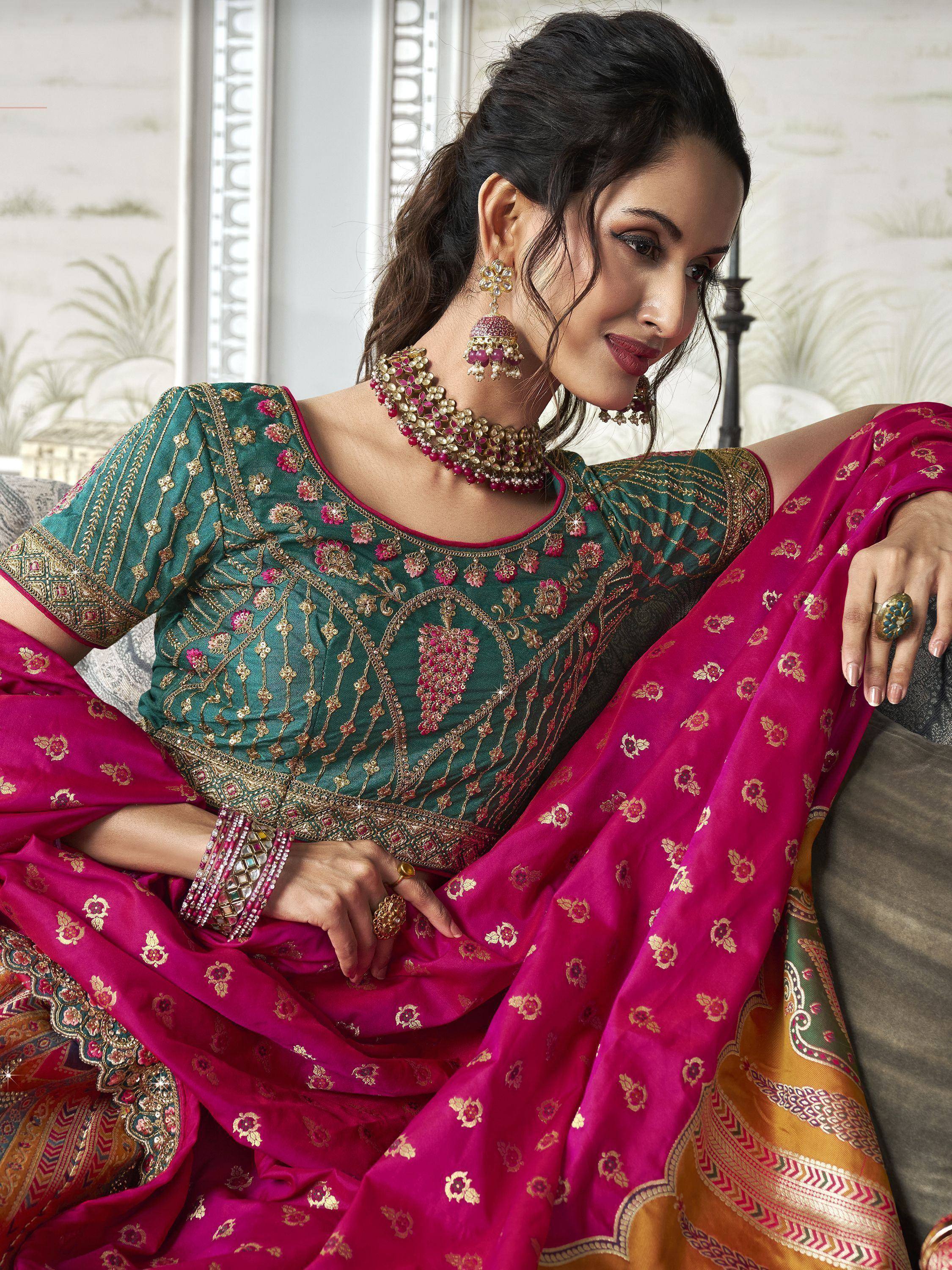 Elegant Indian ethnic wear: teal embroidered blouse with magenta saree, perfect for weddings and festivals.