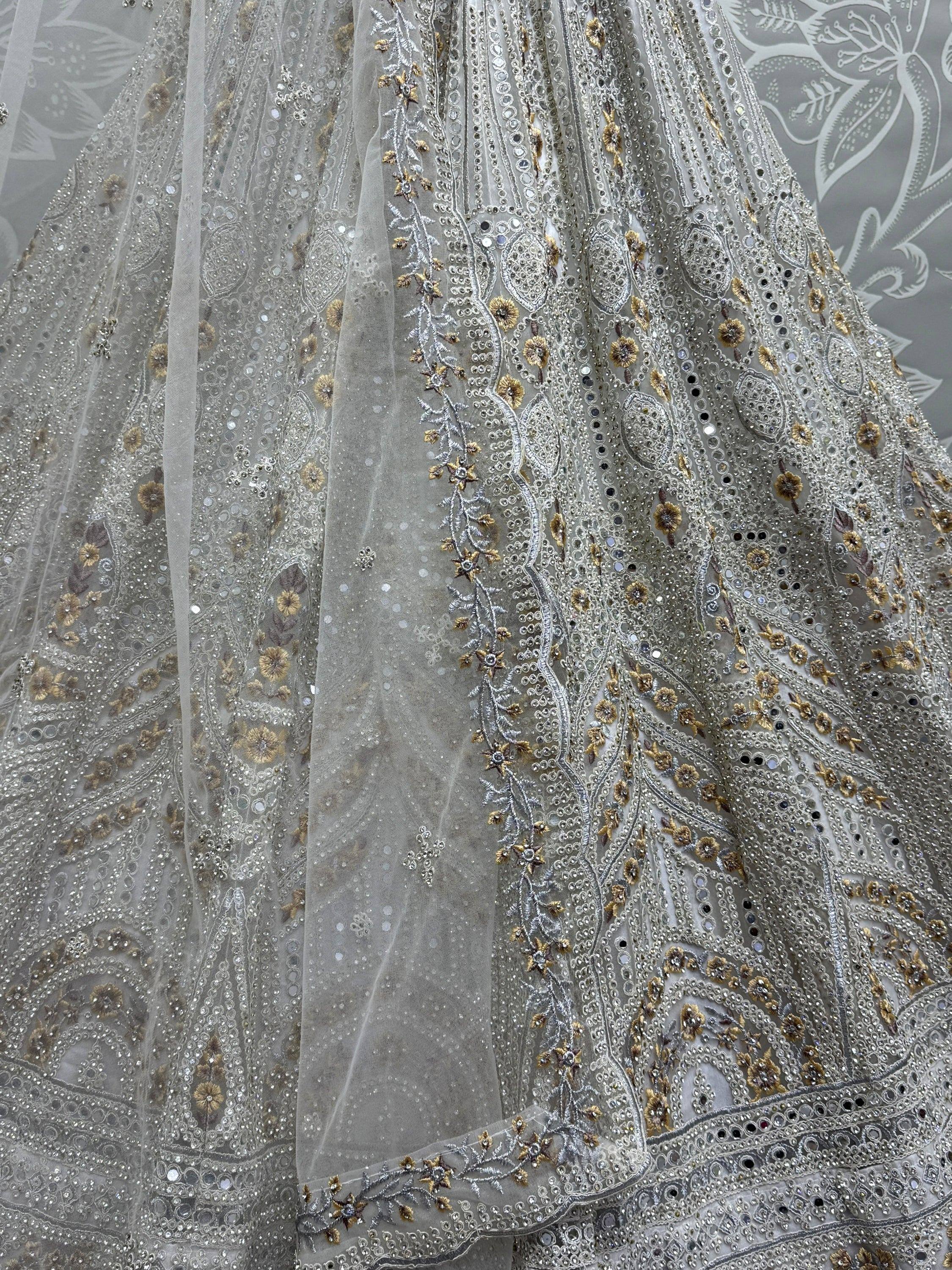 Silver and gold embroidered lehenga with intricate floral and mirror work, perfect for Indian ethnic wear.