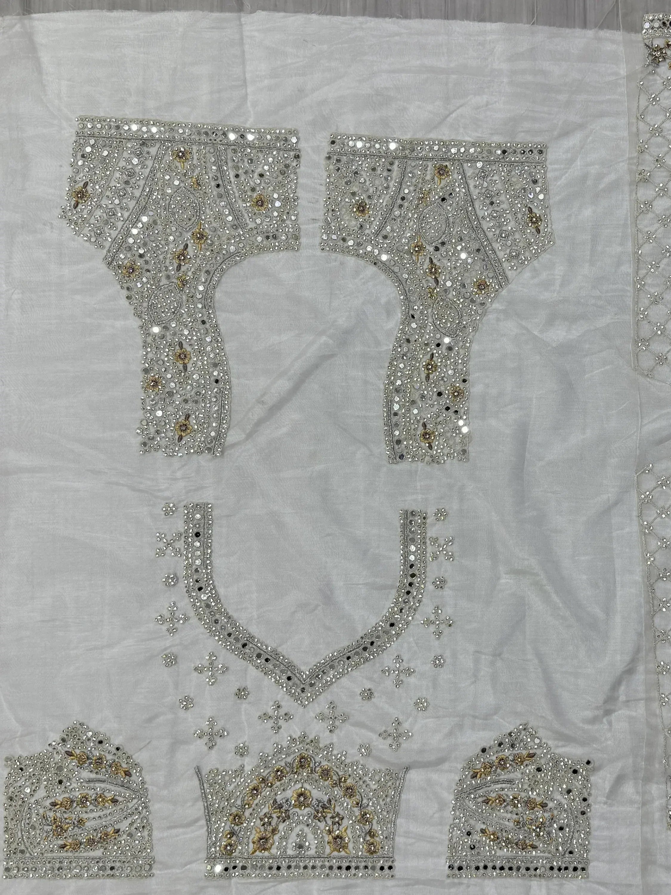 White ethnic wear fabric with intricate silver and gold mirror work embroidery for designer lehenga or salwar kameez