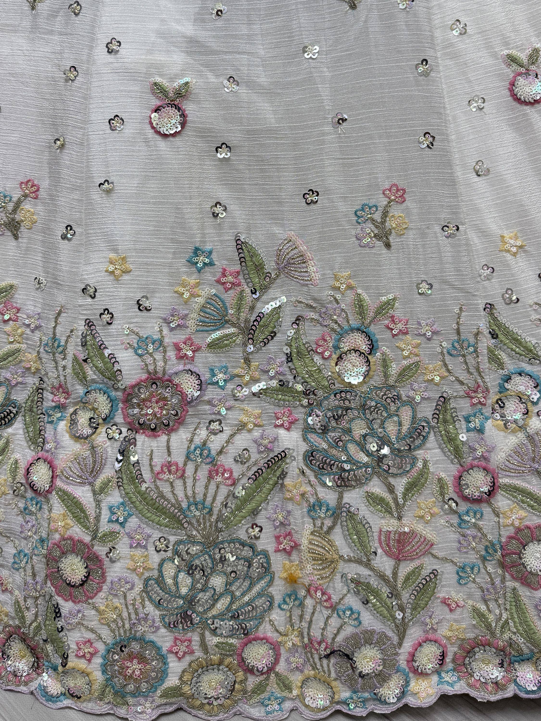 Floral sequin embroidery on light grey ethnic wear fabric, featuring colorful flowers and leaves for designer lehenga or saree