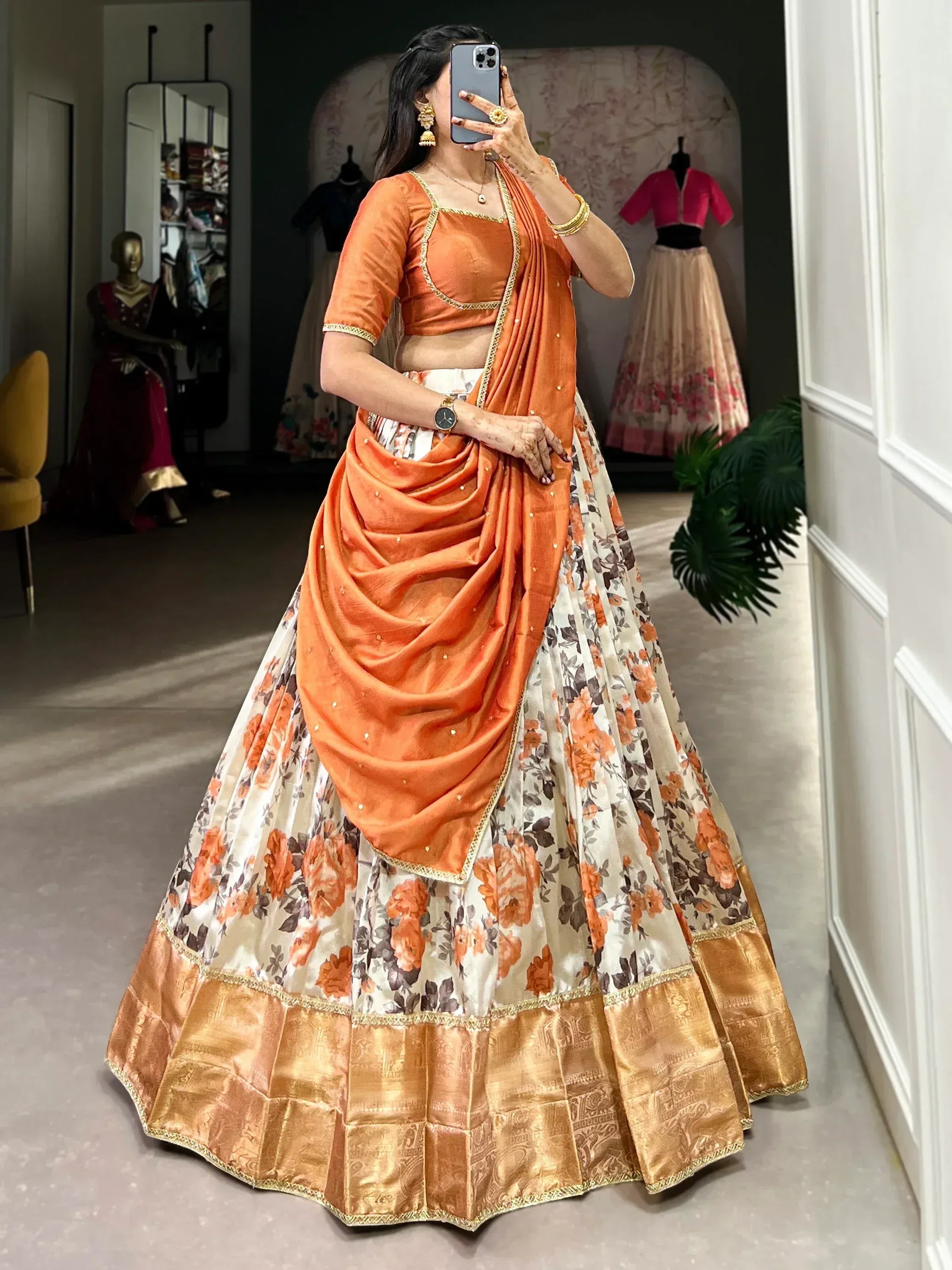 Orange floral lehenga choli with gold border, perfect for Indian ethnic wear and festive occasions
