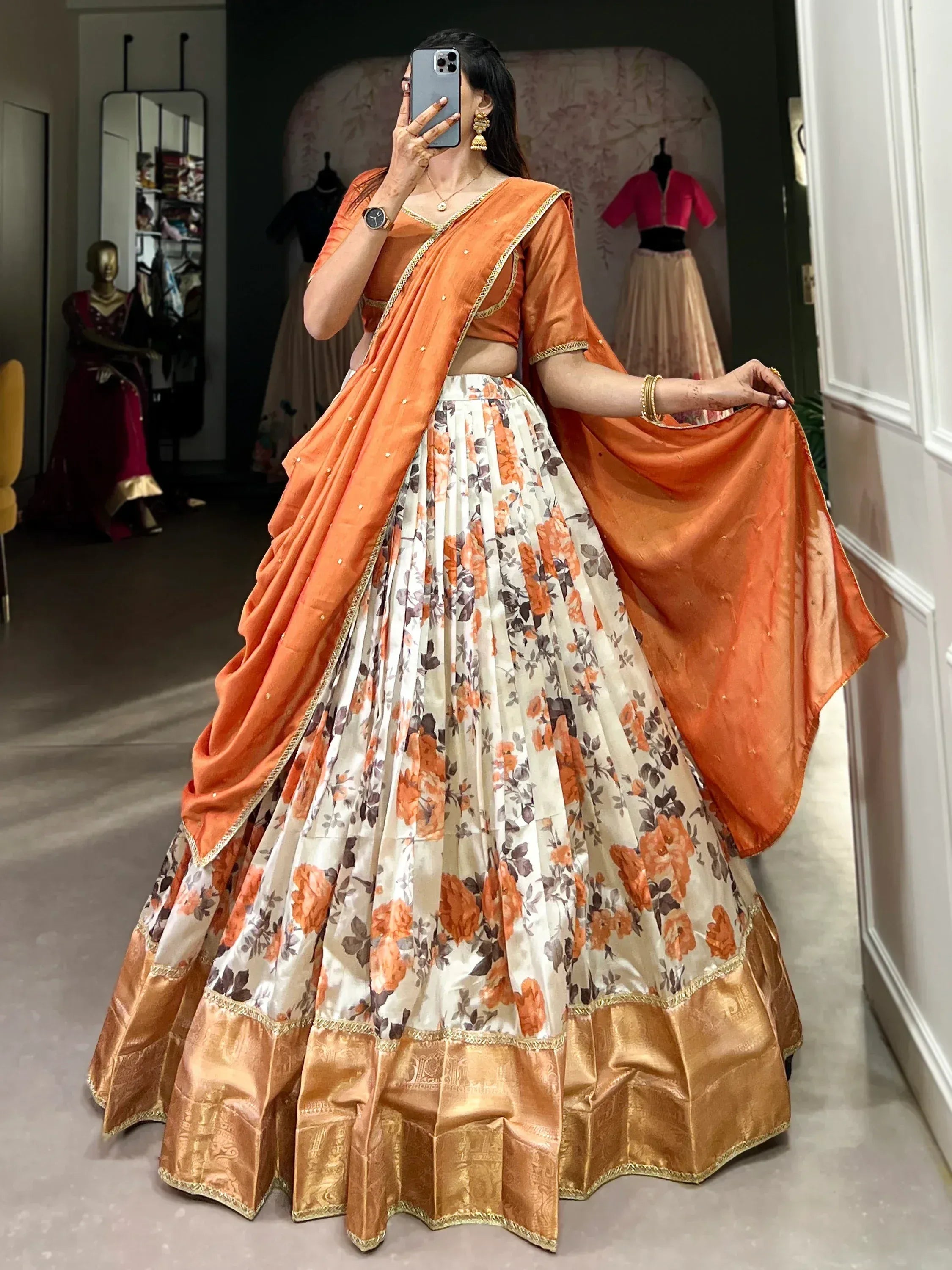 Orange floral lehenga choli with gold border, perfect for Indian ethnic wear and festive occasions.