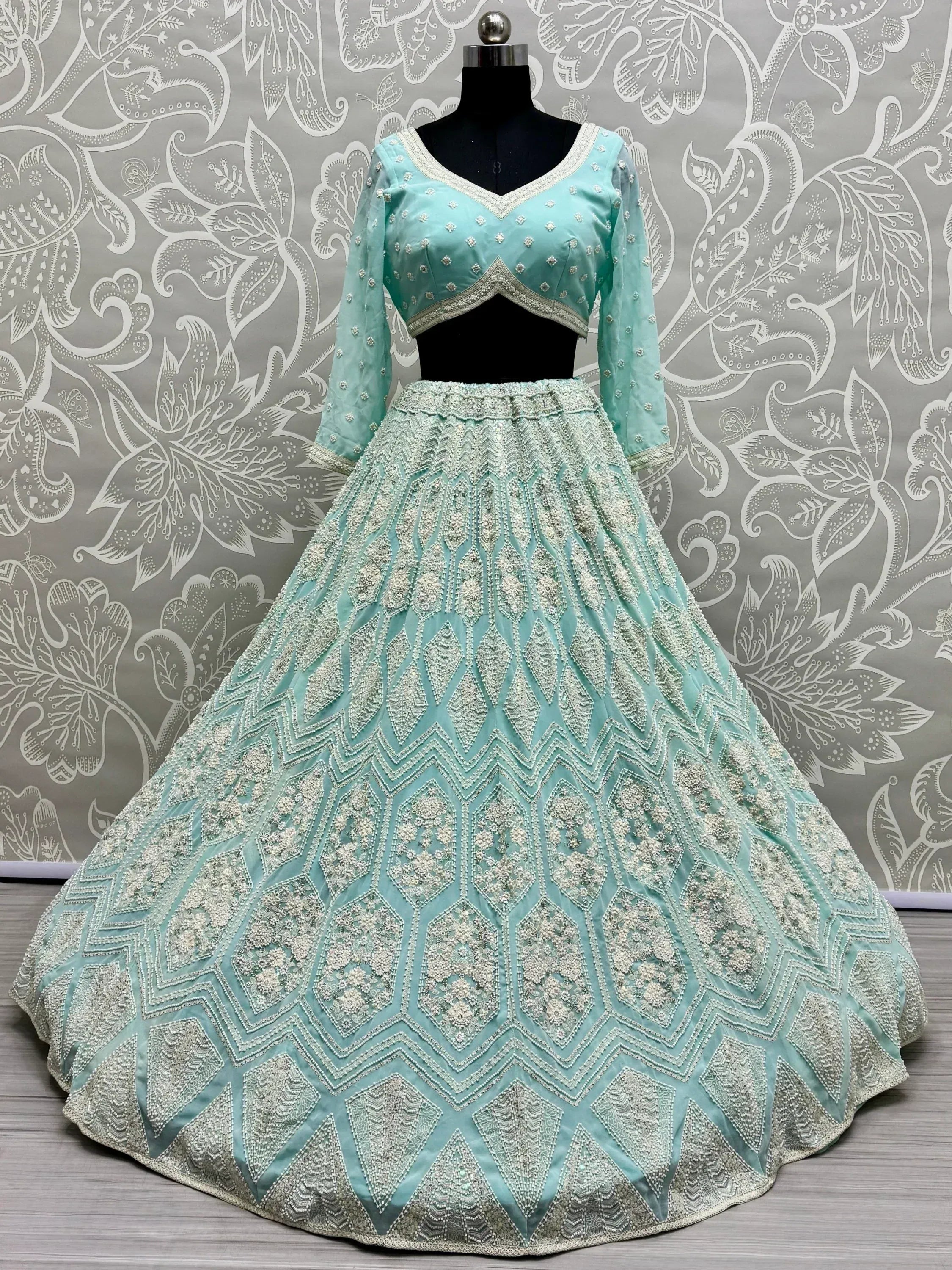 Mint green designer lehenga choli with heavy silver embroidery, perfect for Indian weddings and festive occasions.
