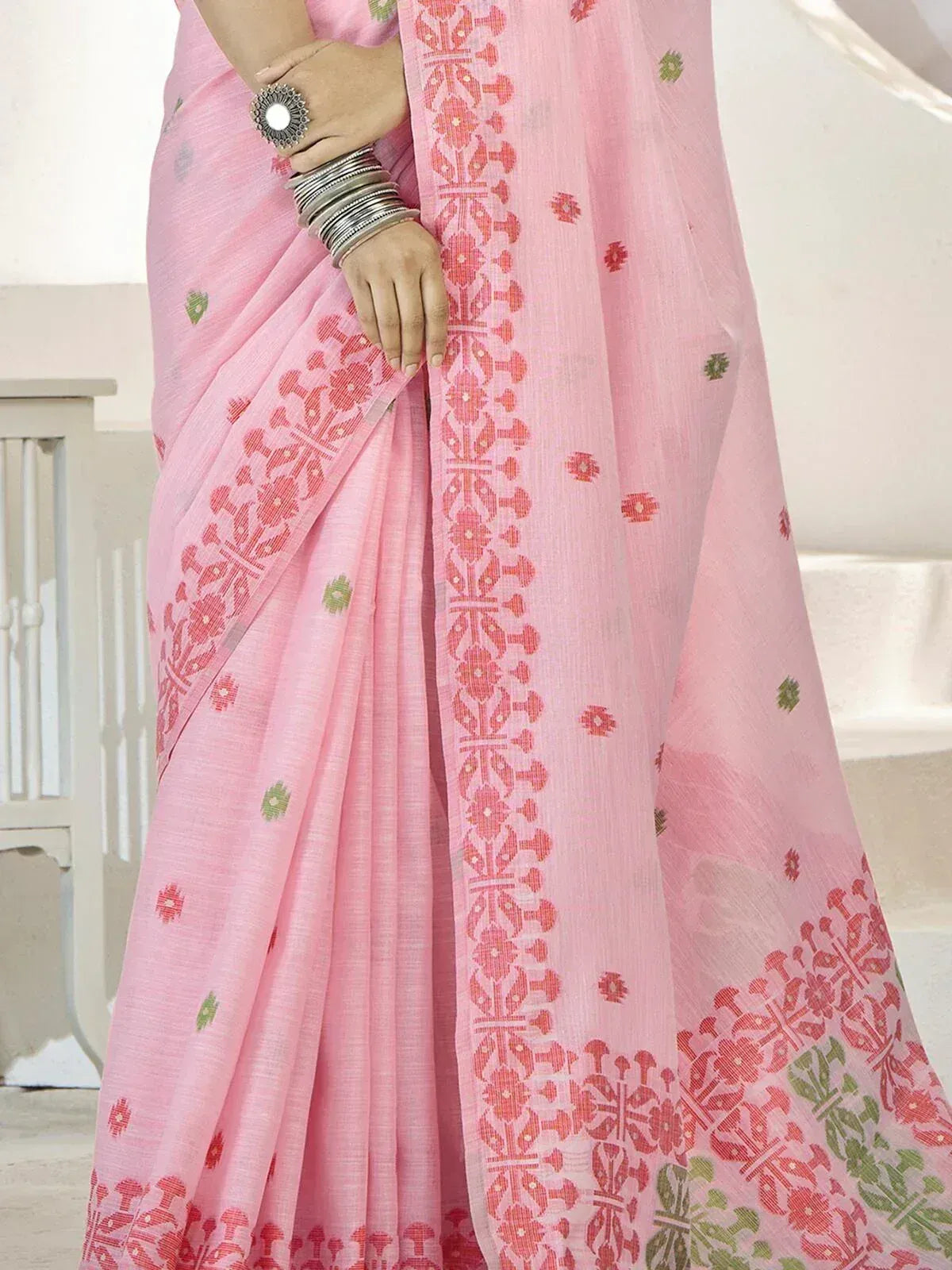Pink printed saree with red and green floral motifs, ethnic Indian wear