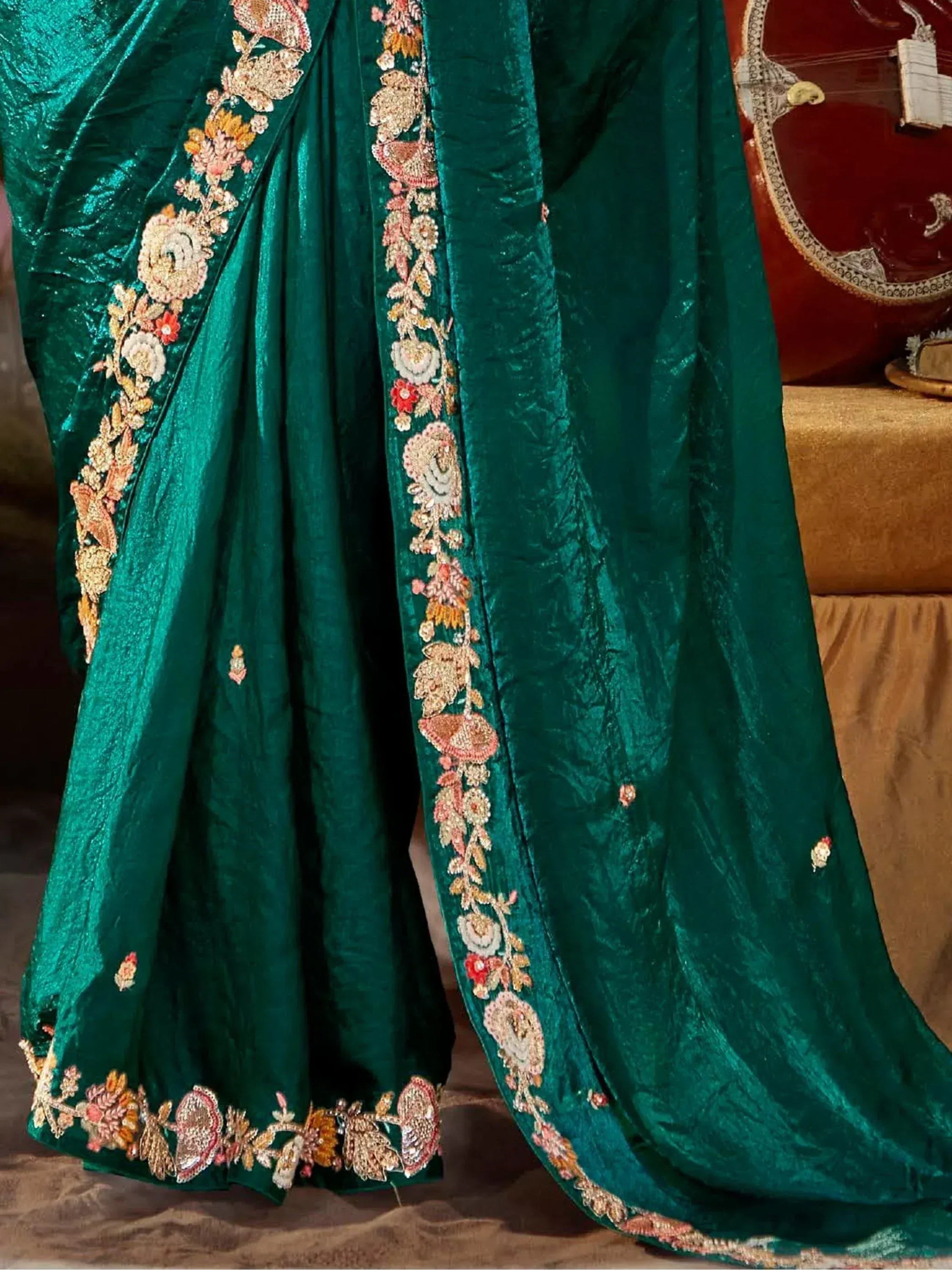 Emerald green velvet saree with floral embroidery, perfect for Indian ethnic wear occasions.