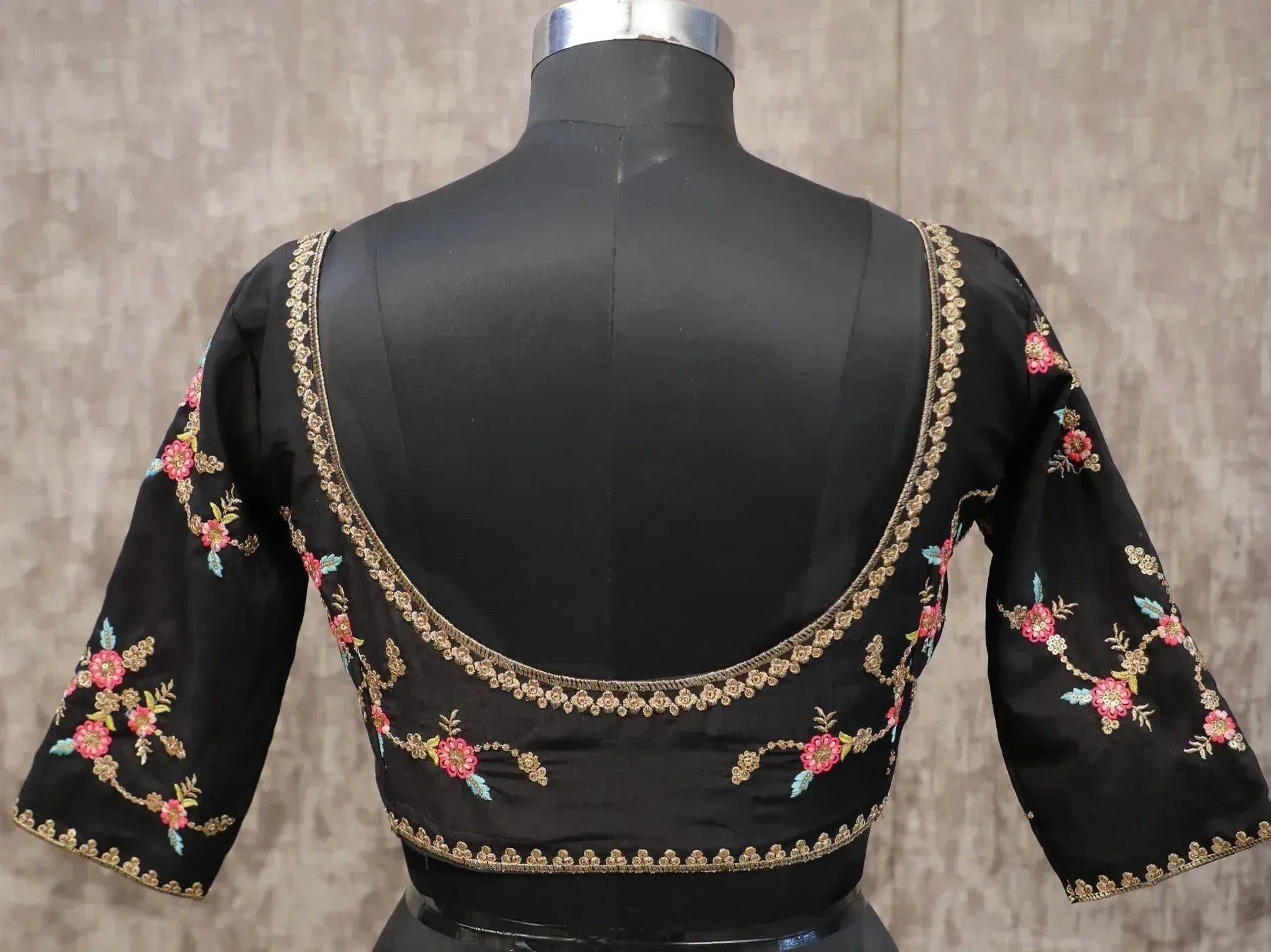 Black embroidered blouse with floral design, perfect for lehenga choli or saree, featuring gold trim and 3/4 sleeves.