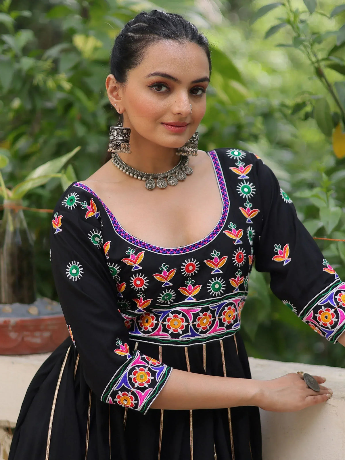 Black embroidered ethnic gown with colorful floral motifs, perfect for Indian occasions and festive wear.