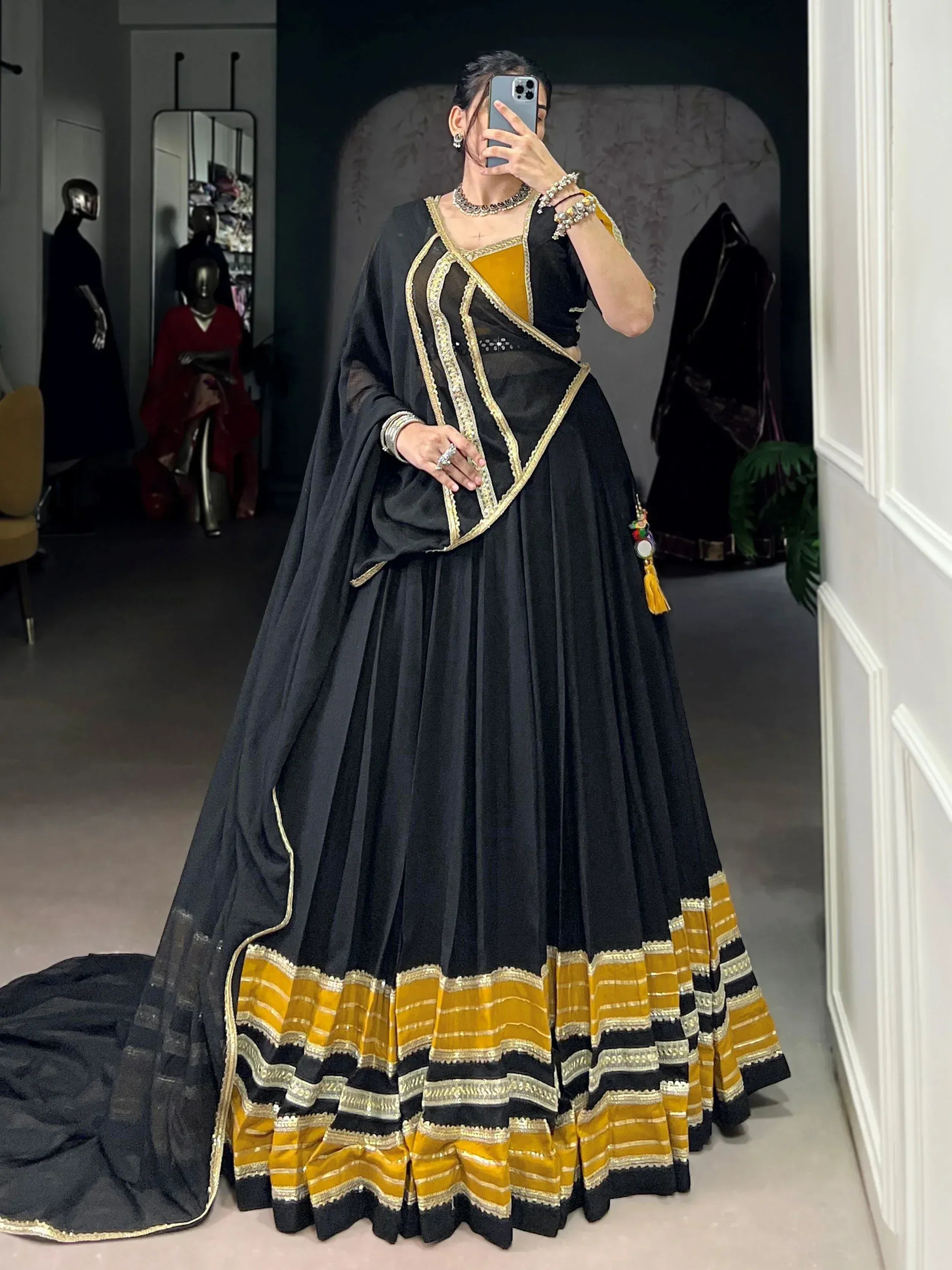 Black and mustard Indian designer lehenga choli with gold embroidery, perfect for weddings and festive occasions.