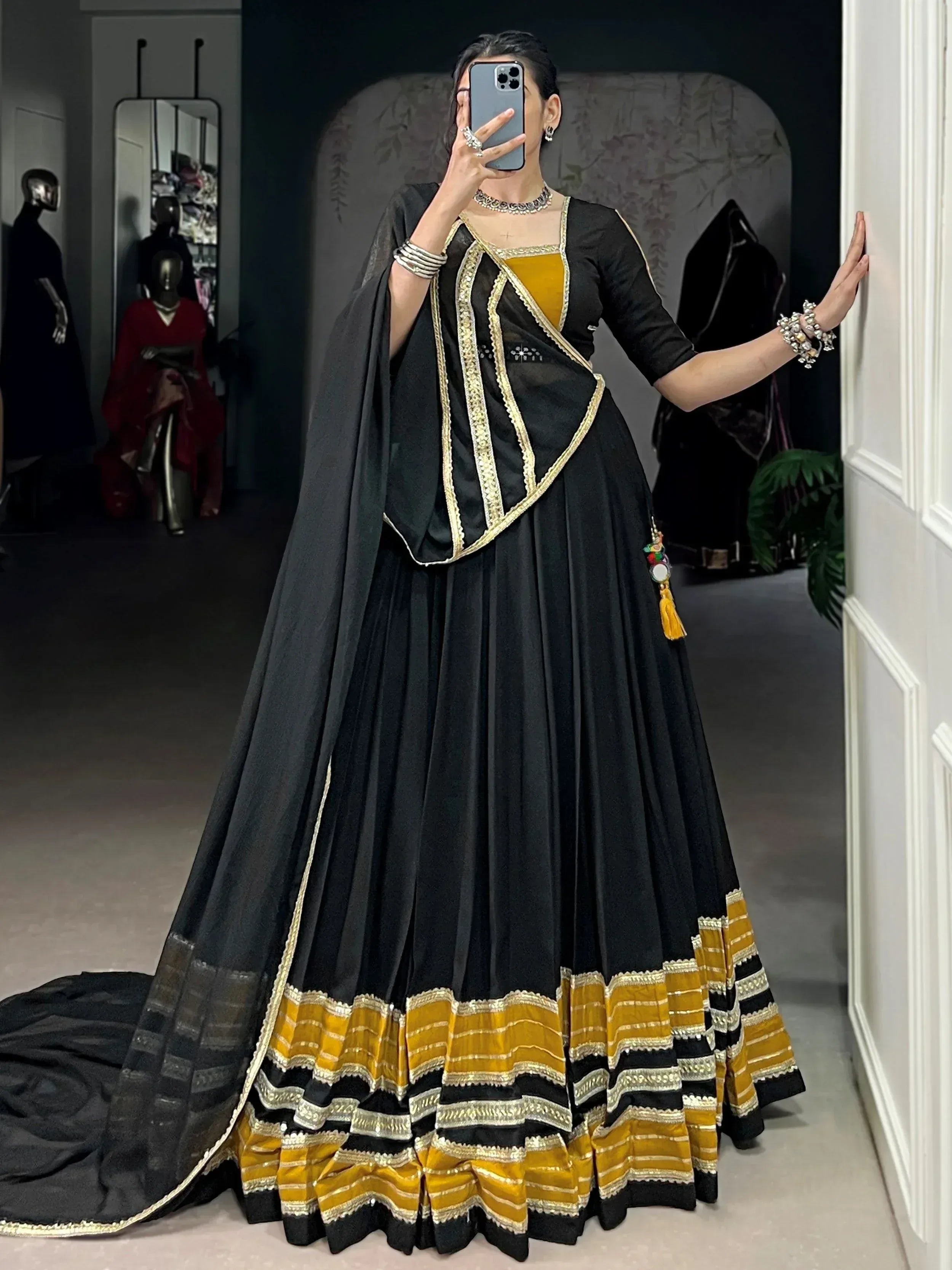 Black and mustard yellow designer lehenga choli with gold embroidery, perfect for Indian ethnic wear occasions.