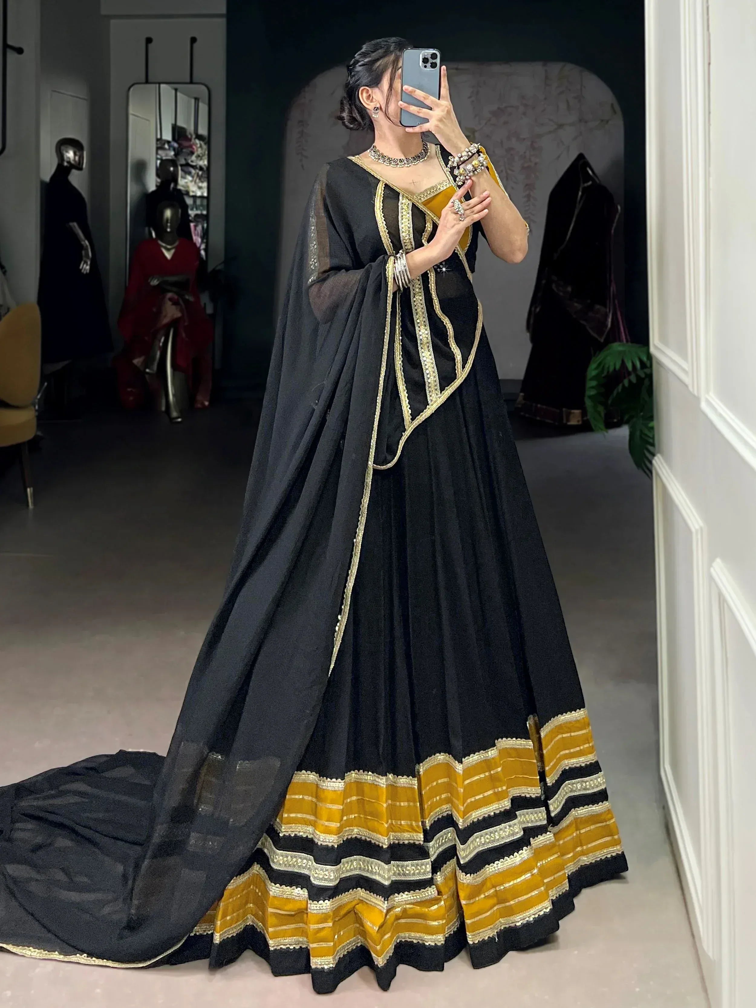 Black and gold designer lehenga choli with intricate embroidery, perfect for Indian ethnic wear events