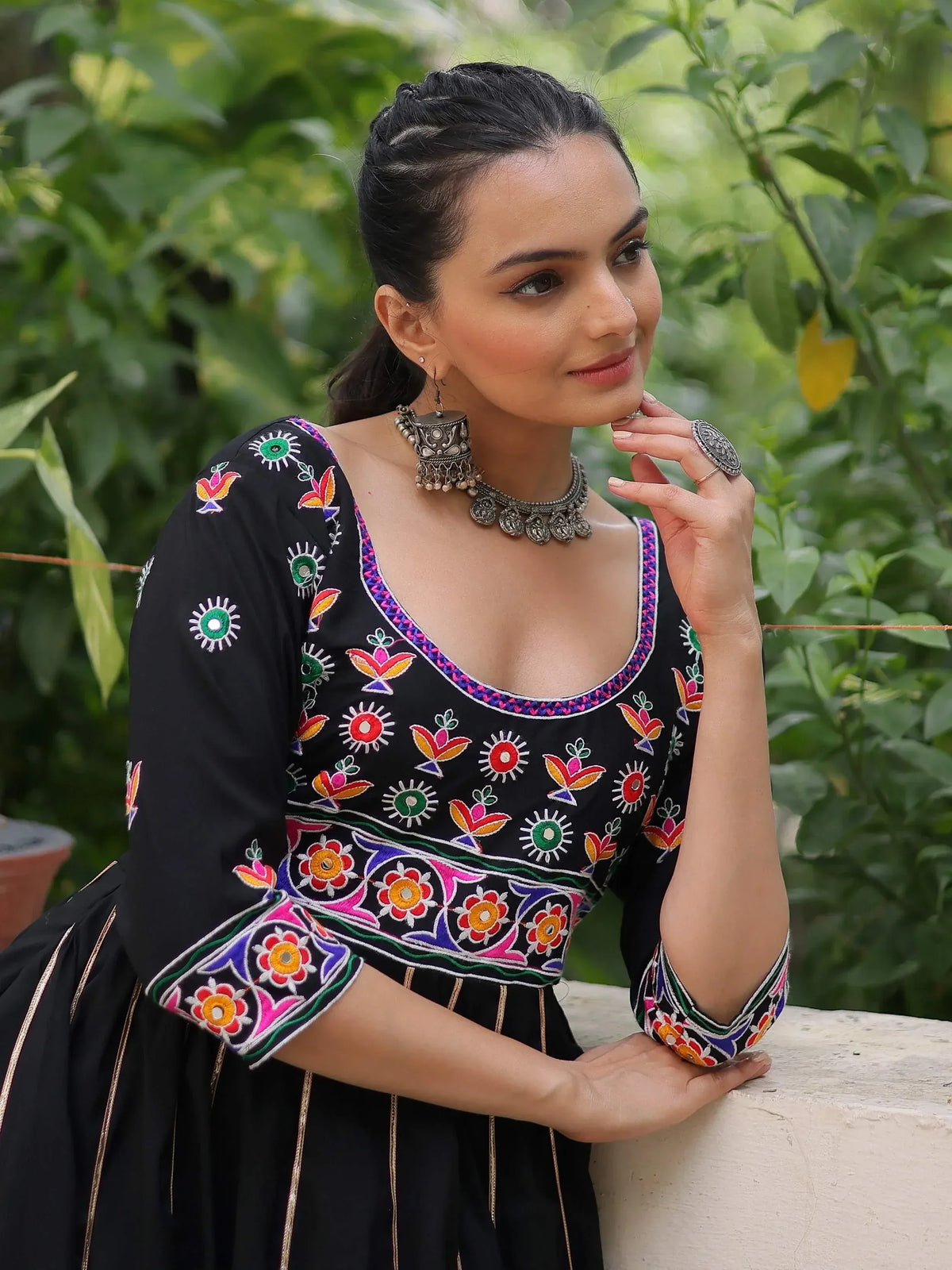 Black ethnic dress with colorful floral embroidery, perfect for Indian occasions and festivals.
