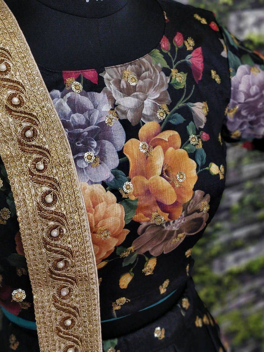 Black floral printed ethnic gown with gold embroidery and pearl detailing, perfect for Indian occasions.