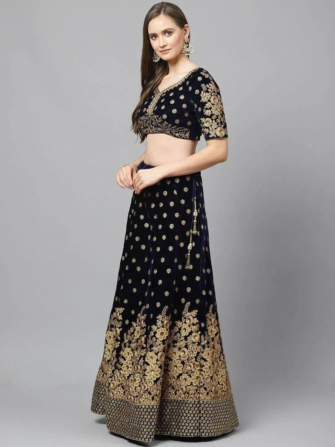 Navy blue velvet lehenga choli with gold floral embroidery, perfect for weddings and parties