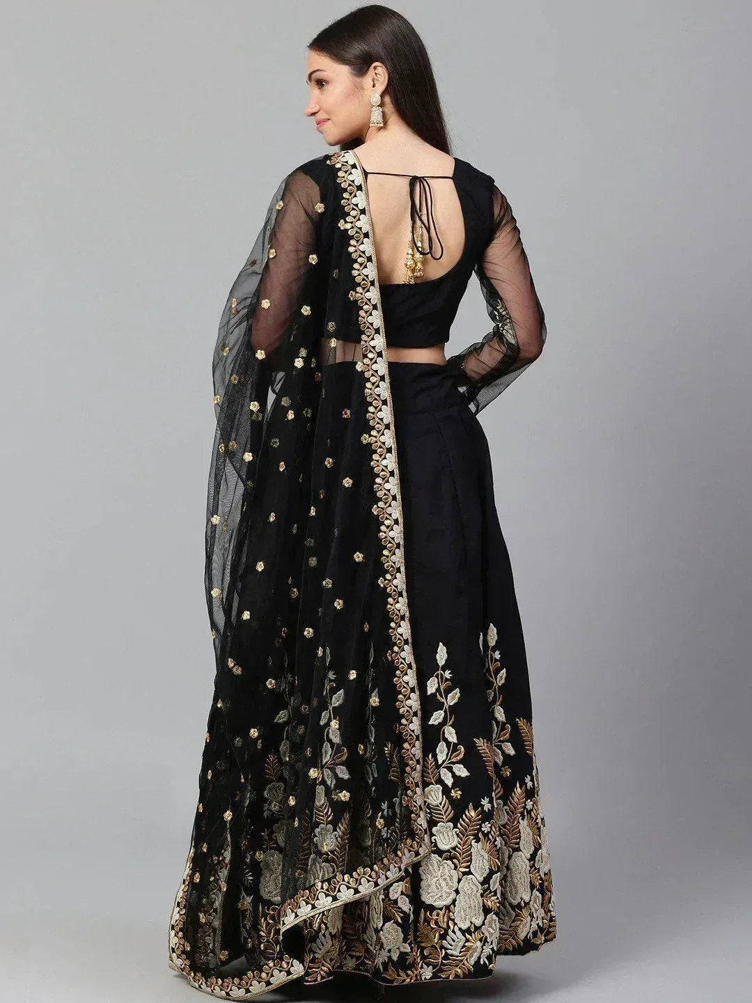 Black embroidered lehenga choli with sheer dupatta, floral gold detailing, backless blouse for ethnic wear