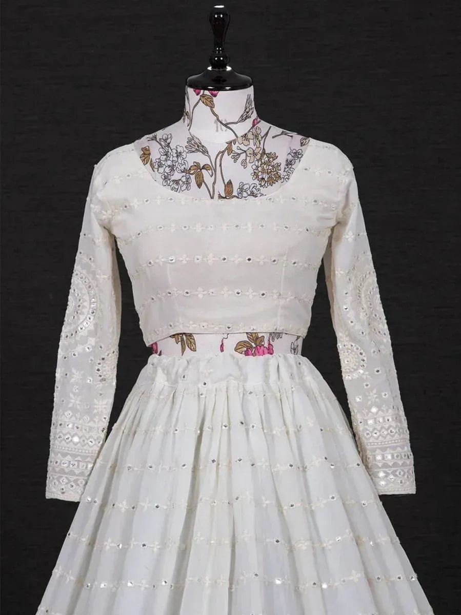 White floral embroidered ethnic gown with mirror work and long sleeves, perfect for Indian occasions