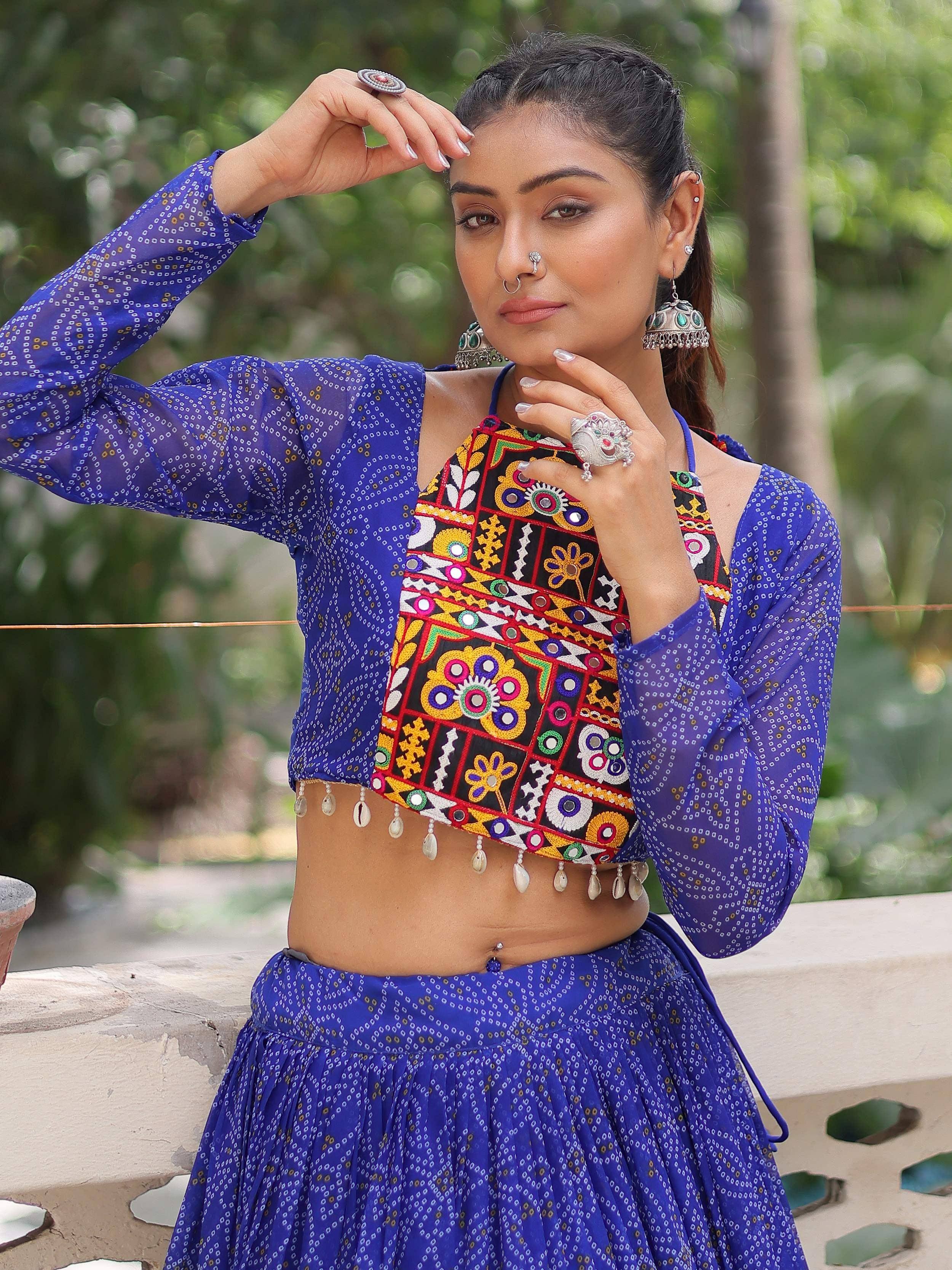 Blue printed ethnic crop top with mirror work and shell tassels, paired with matching skirt
