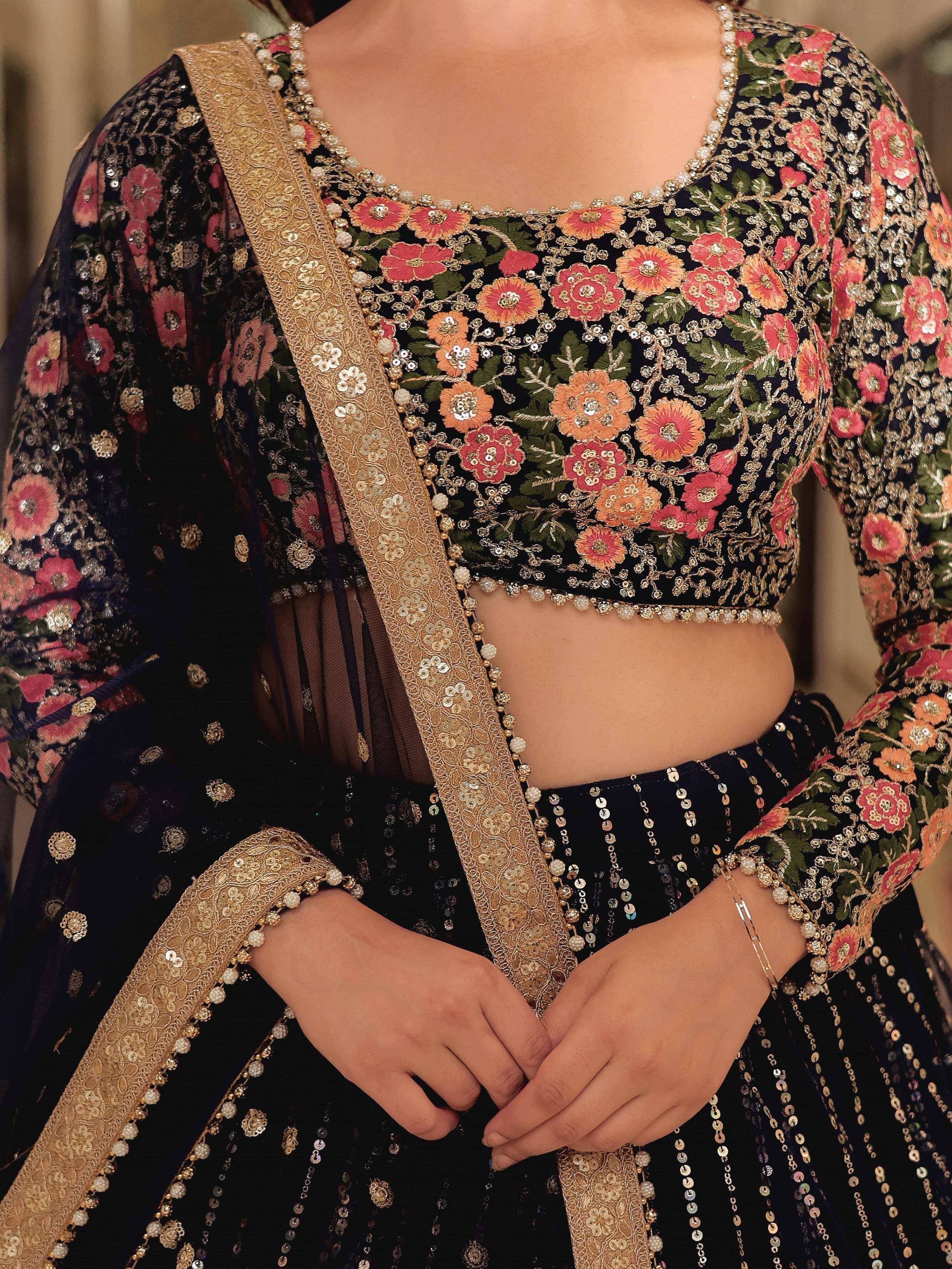 Black floral embroidered lehenga choli with gold sequin detailing and pearl trim, perfect for Indian ethnic wear.