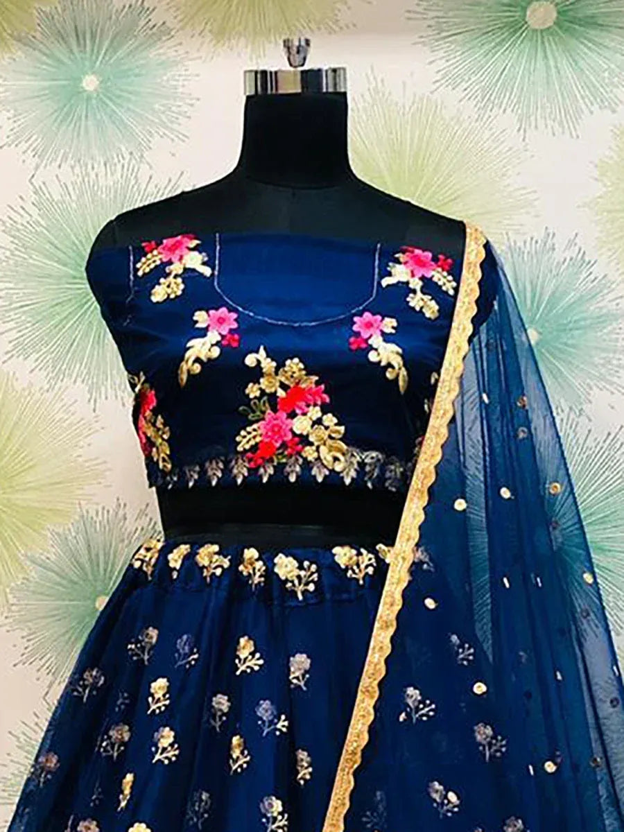 Navy blue embroidered lehenga choli with floral motifs and gold trim, displayed on mannequin