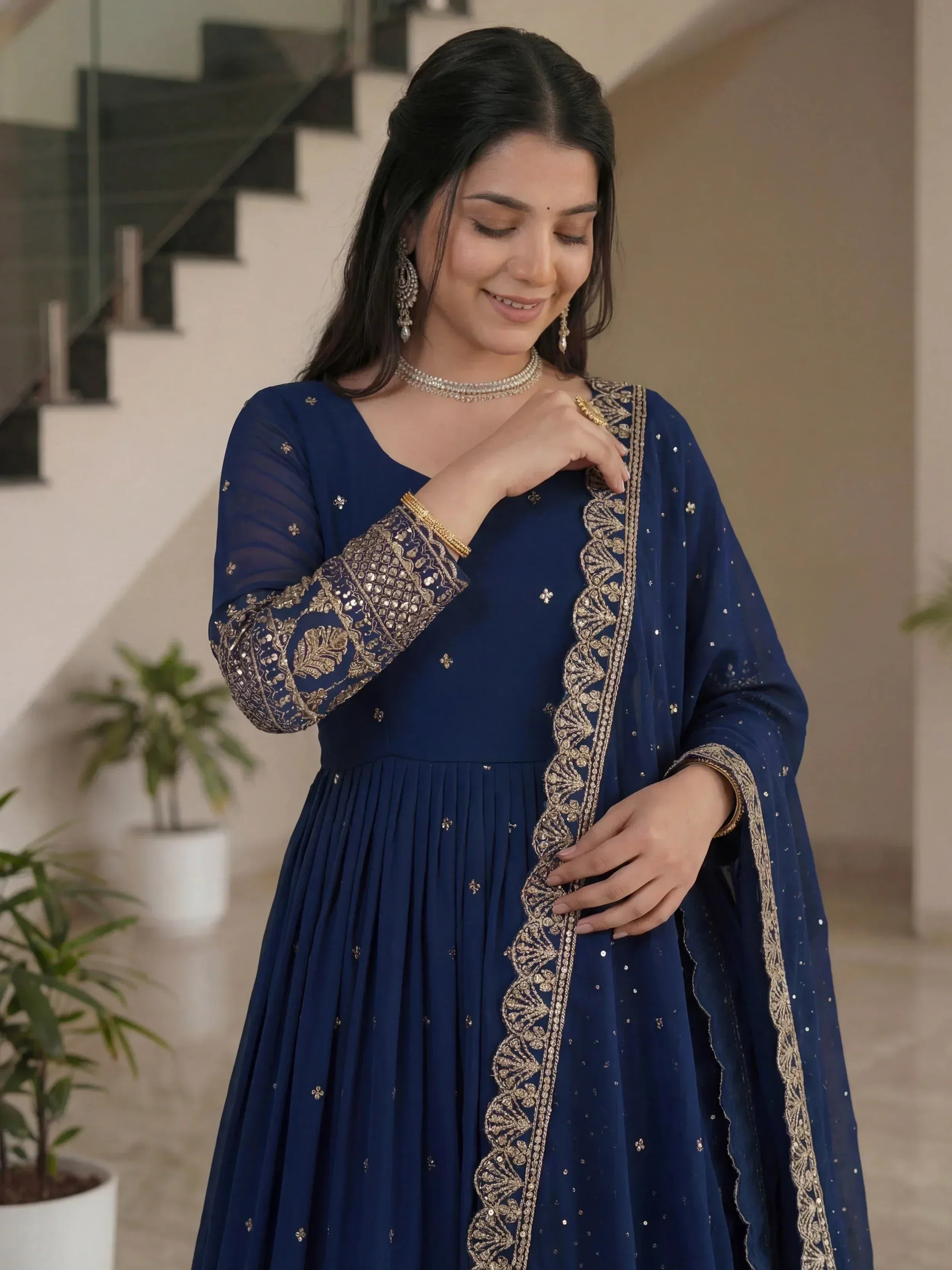 Navy blue ethnic gown with gold embroidery, perfect for Indian weddings and festive occasions.