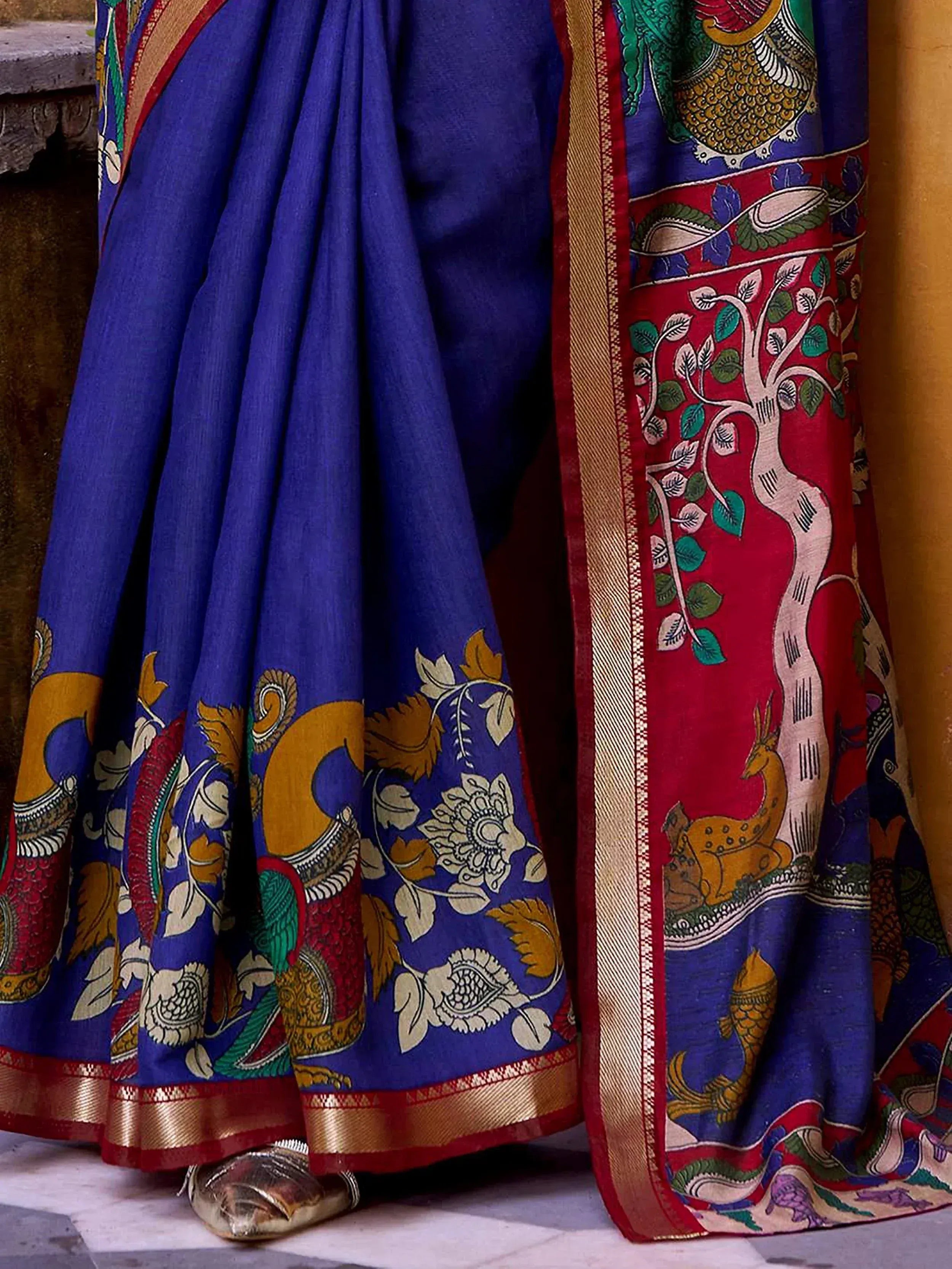 Royal blue saree with peacock, tree, and deer motifs, gold border, ethnic Indian wear