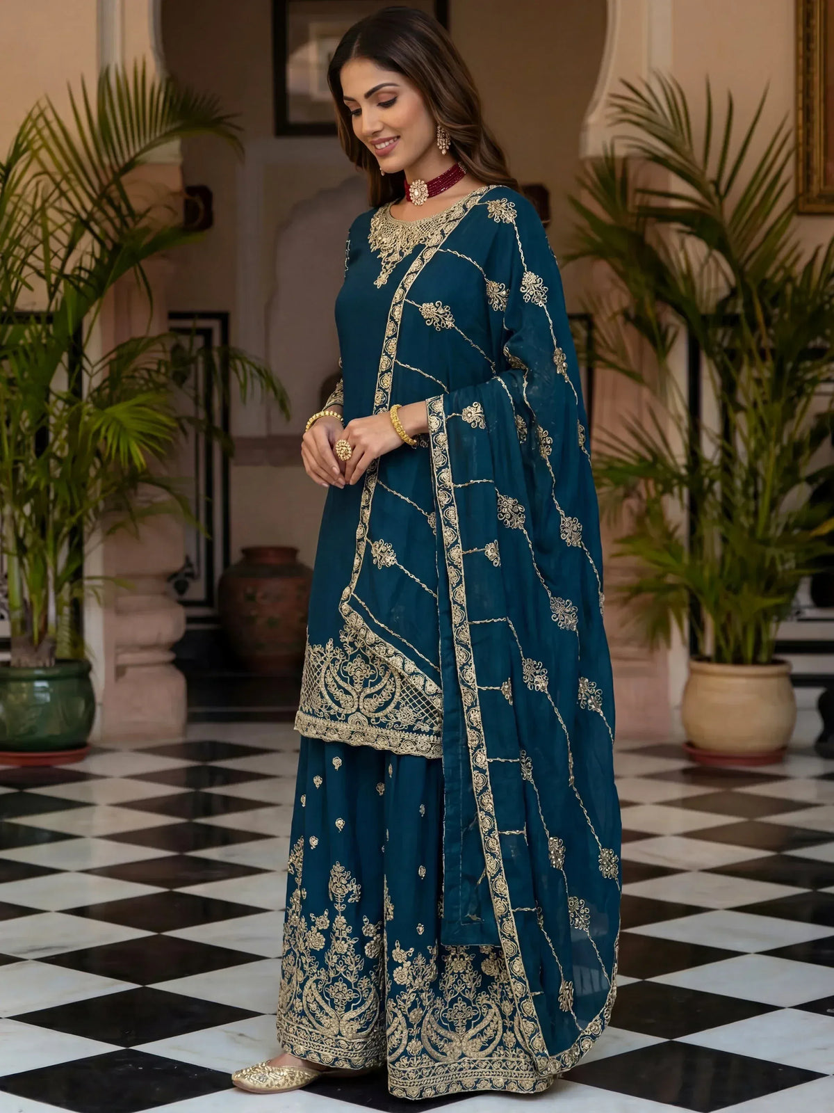 Teal blue embroidered salwar kameez with gold detailing, perfect for Indian ethnic wear occasions.