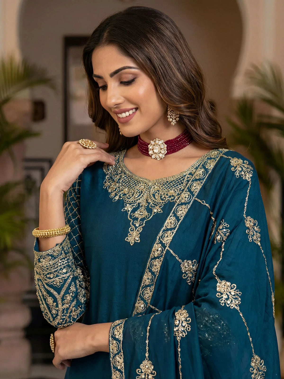 Teal ethnic gown with gold embroidery, perfect for Indian occasions and festive wear.