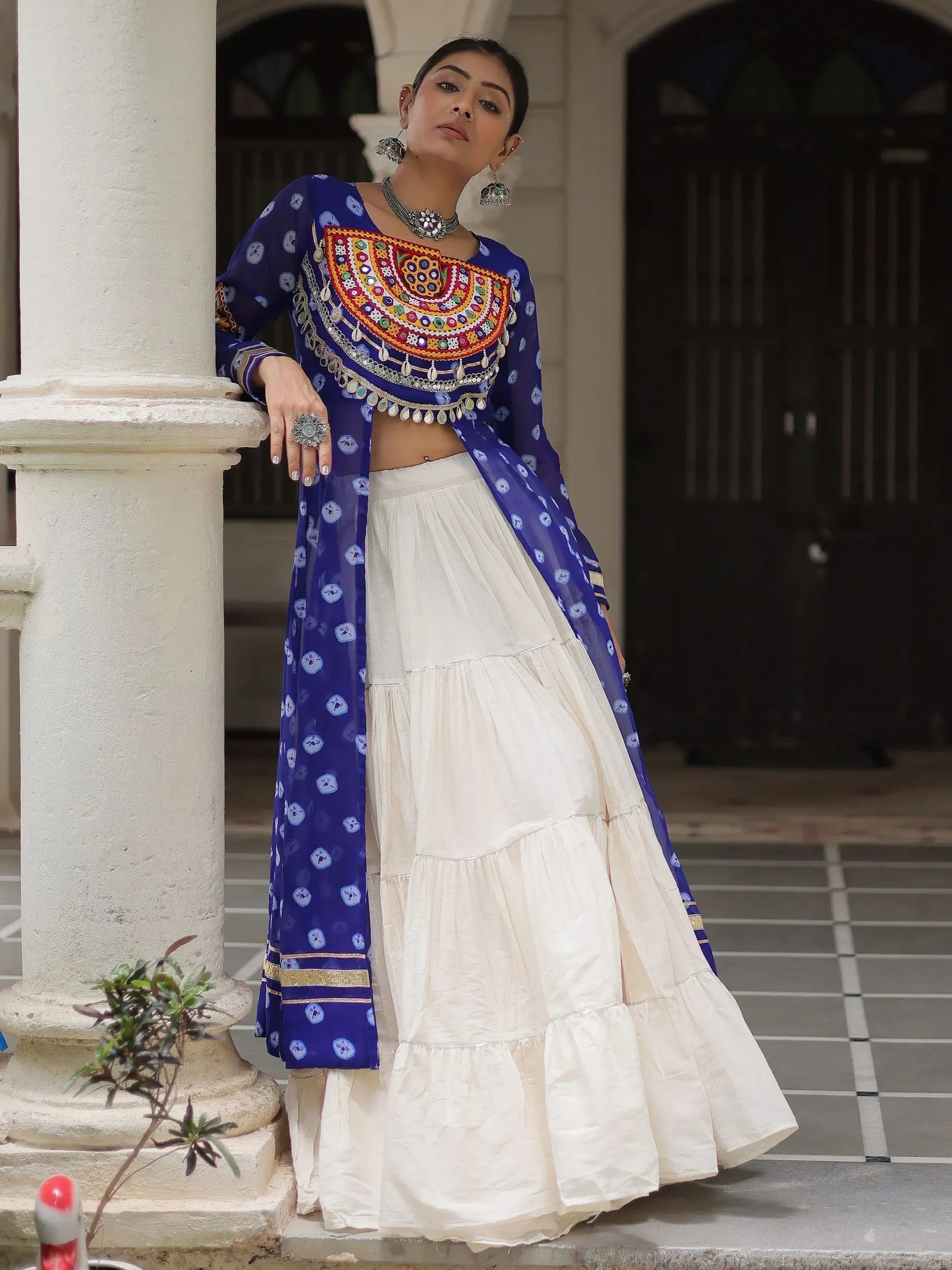 Woman in blue embroidered crop top with white tiered skirt, Indian ethnic wear