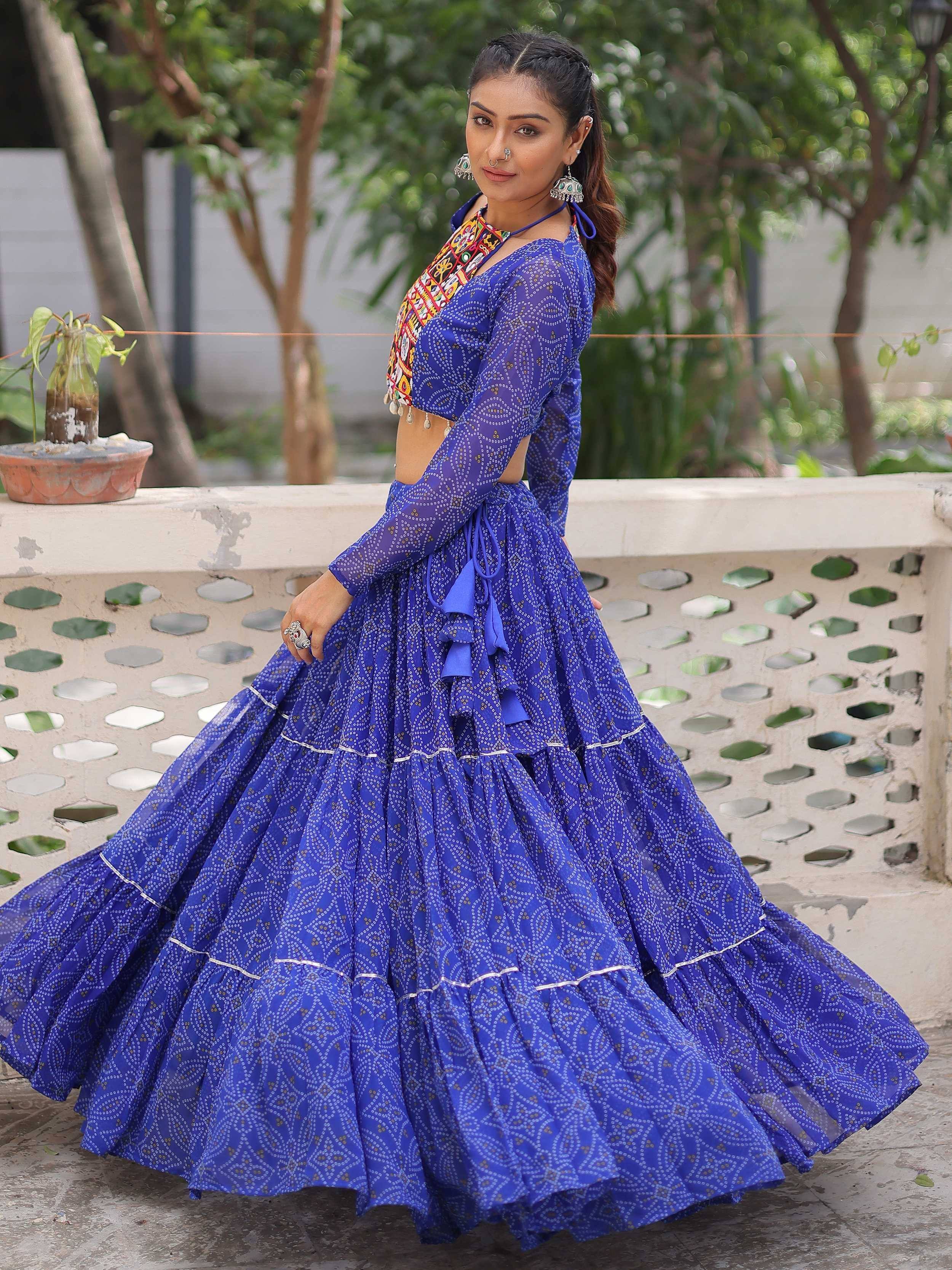 Woman in royal blue printed lehenga choli with embroidered blouse, perfect for Indian ethnic occasions